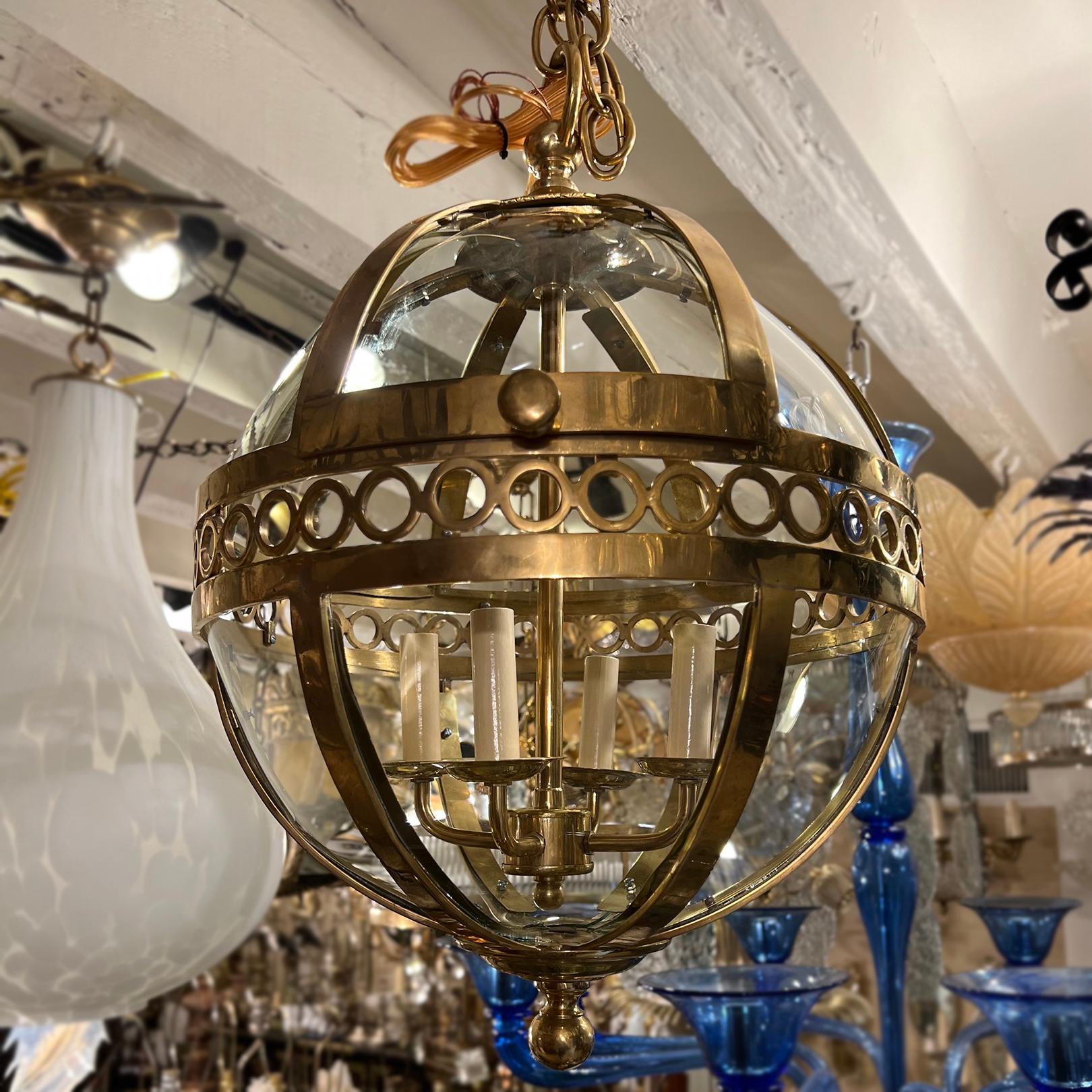 A set of three circa 1950's French cast bronze globe lanterns with four interior lights each. Sold individually. Can be dark patinated.

Measurements:
Minimum drop: 24
Diameter: 16.5
