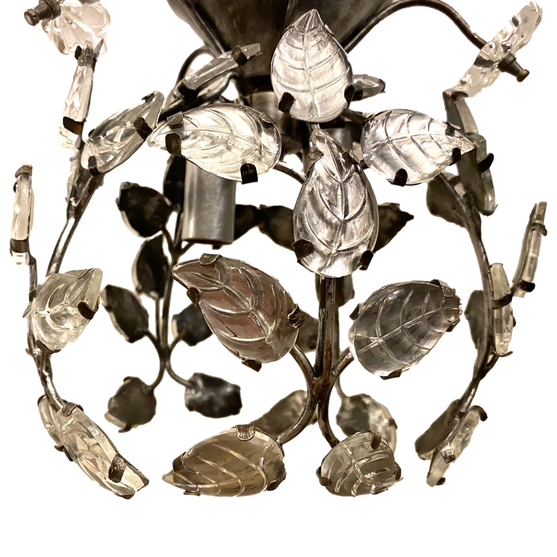 A set of seven French circa 1930's crystal silver leaf pendant light fixtures with molded glass leaves, flowers and two interior lights. Sold individually.

Measurements:
Drop: 12