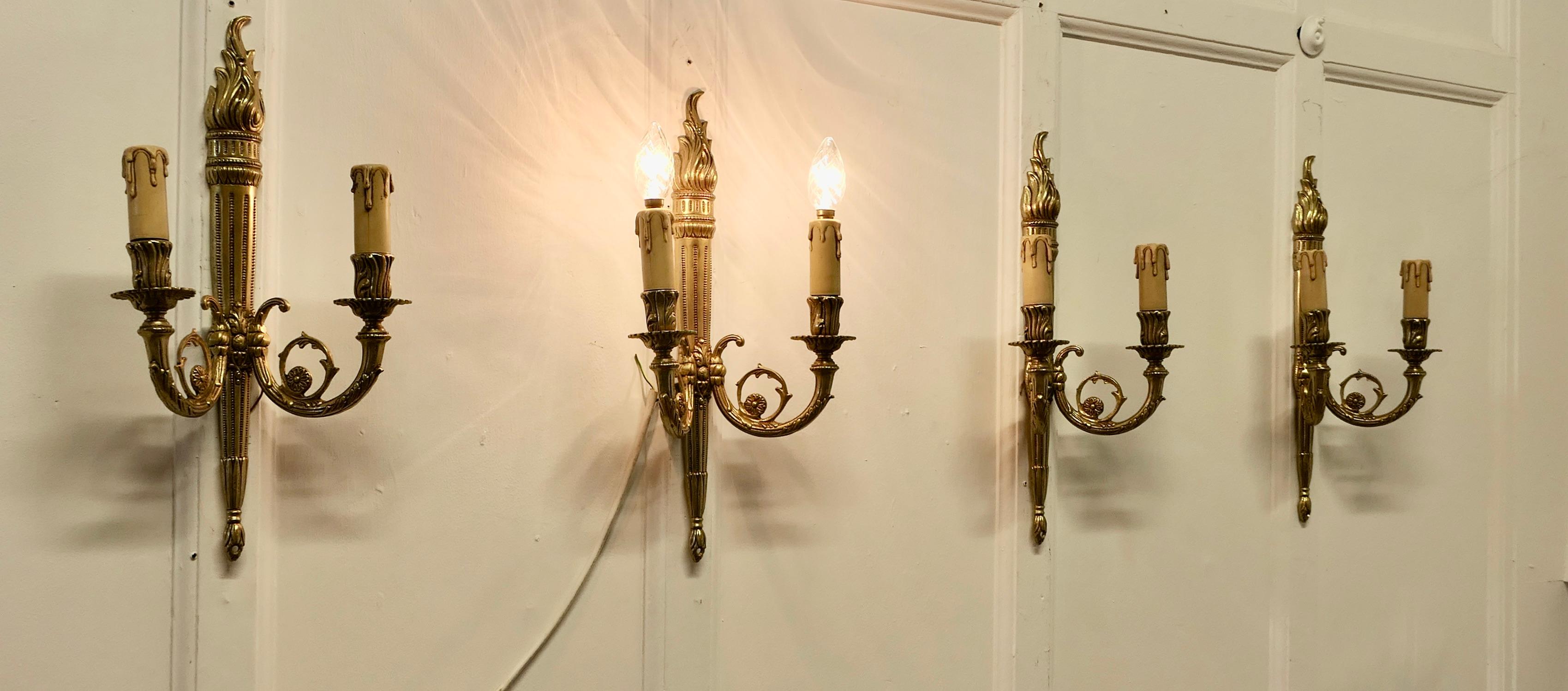 Set of French Neo Classical Large Brass Twin Wall Lights


A very handsome set of Large Heavy Brass wall lights, the lights are in the classical style of a Lighted torch with acanthus leaf scroll branches  
Each light has 2 branches each with a