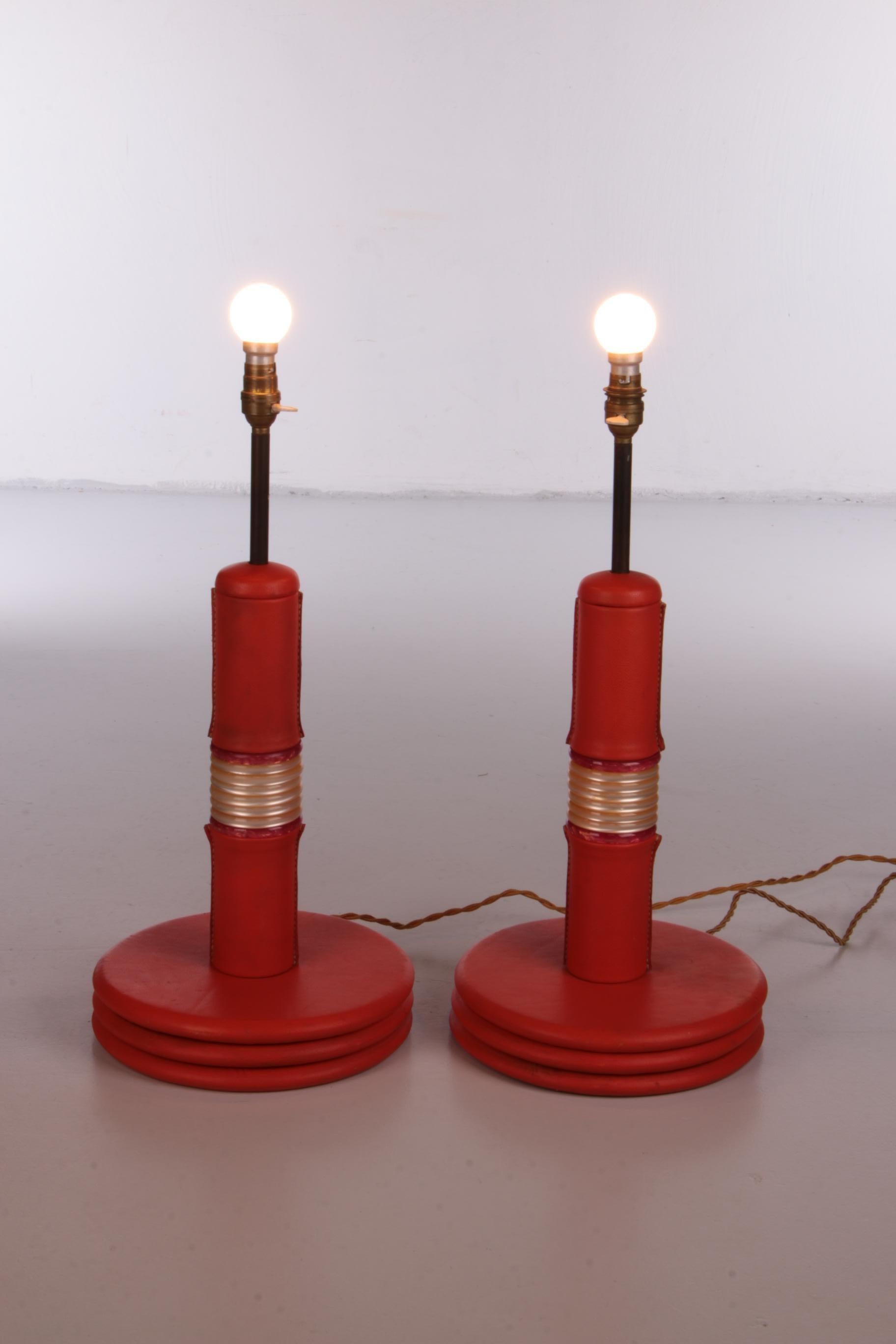 This is a beautiful set of two French lamp bases, created in the 1960s. A real eye-catcher in any room because of its bright color and special leather upholstery.

The design is so unique because it is expertly covered with leather, which is