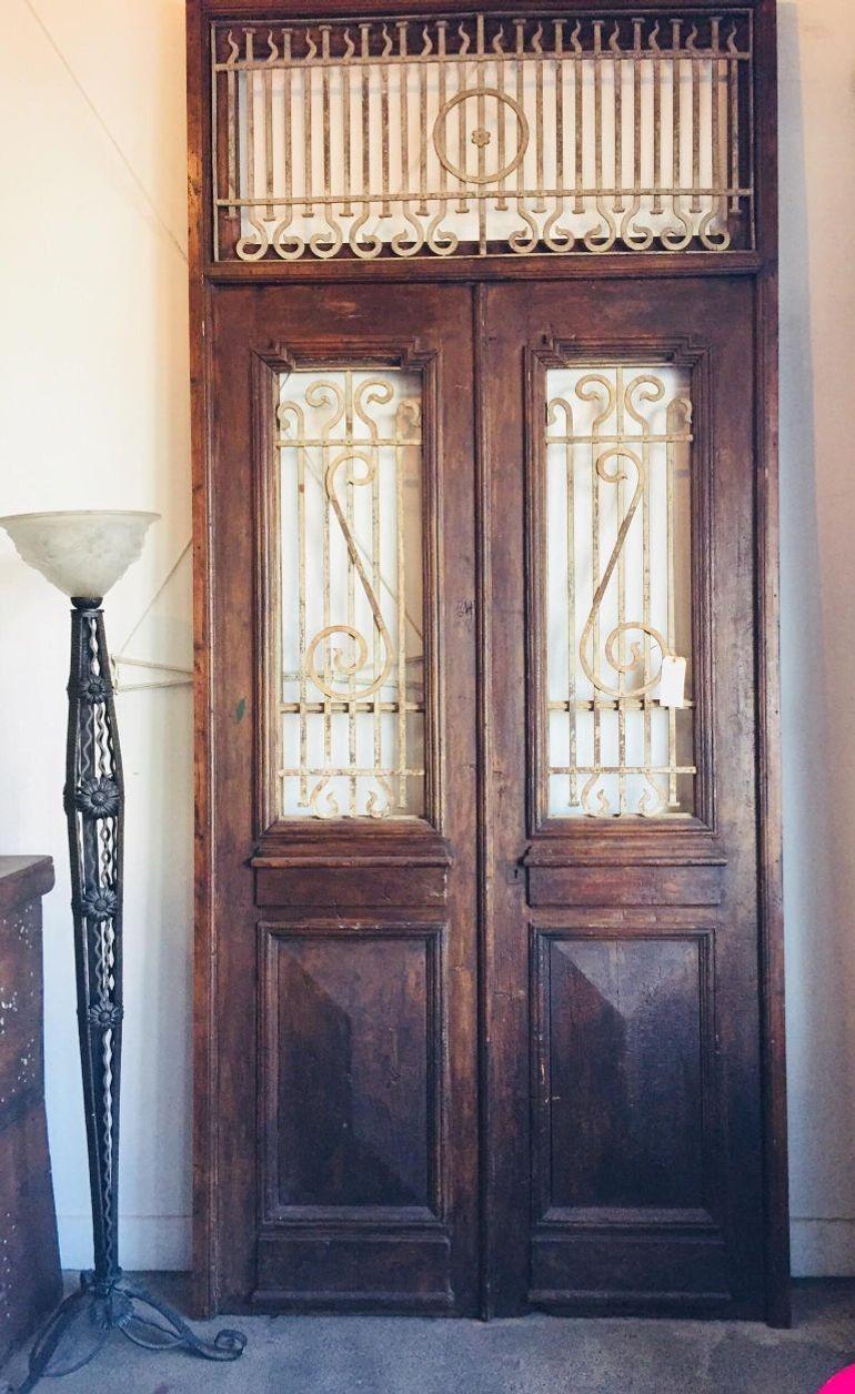 Large French painted double entry doors with transom frame.
Wrought Iron work insert in door frame and top.
Nice high relief carved wood and iron details.
There is some hardware in the back and brass locker.
There is an option to insert glass of