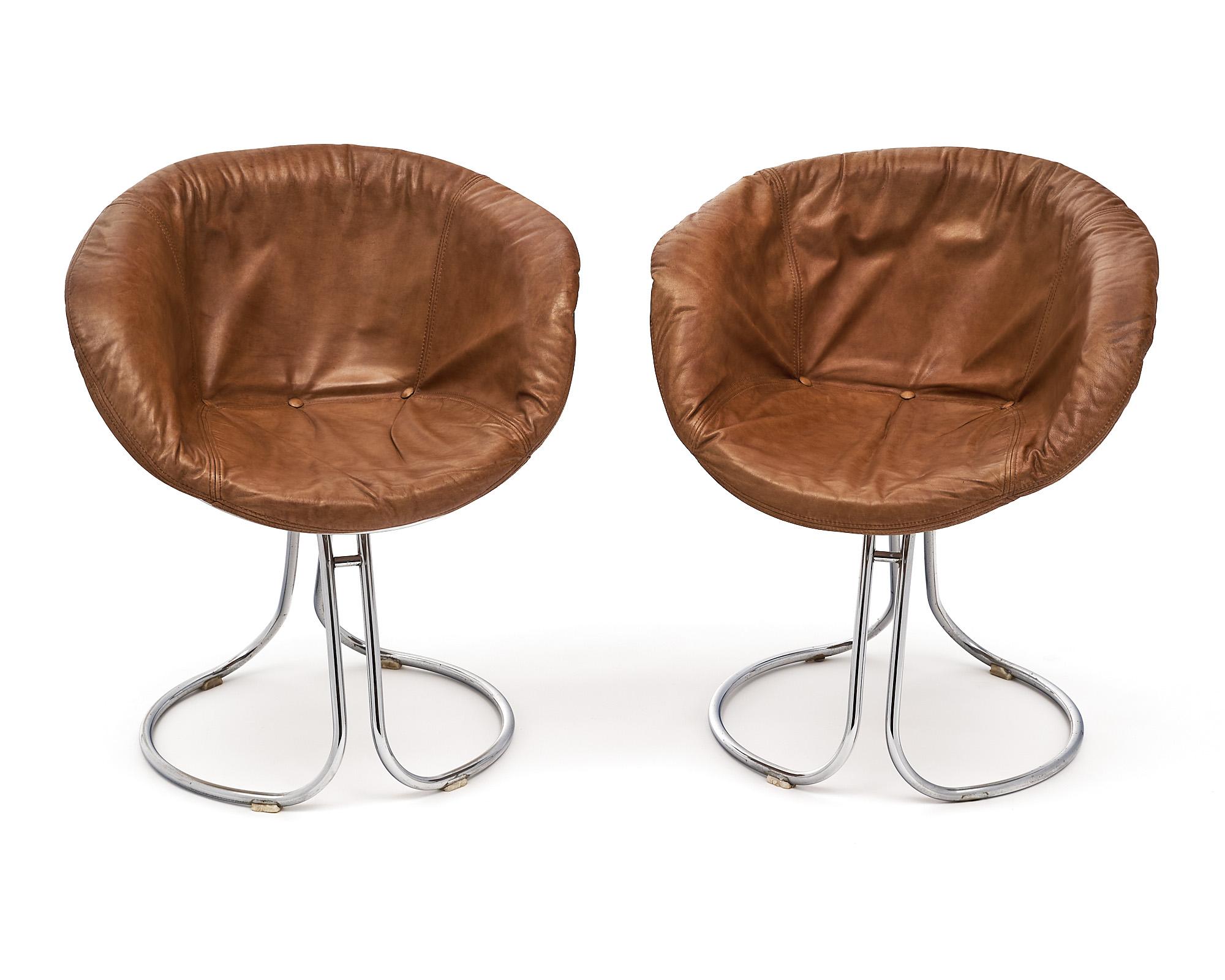 Set of six dining chairs from Italy made with chrome structures and cognac leather seats. These are designed by Gastone Rinaldi and are the Pan Am model from Rima Padova. Each seat has a tubular chrome base and comfortable bucket seat. They are all