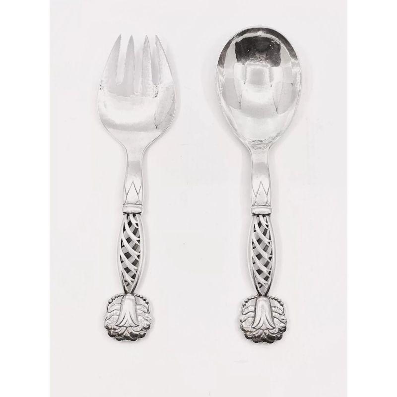 This is a large sterling silver Georg Jensen serving set, fork and spoon, in Ornamental pattern #83 by Georg Jensen from circa 1914.

Additional information:
Material: Sterling silver
Styles: Art Nouveau
Hallmarks: Georg Jensen hallmarks from