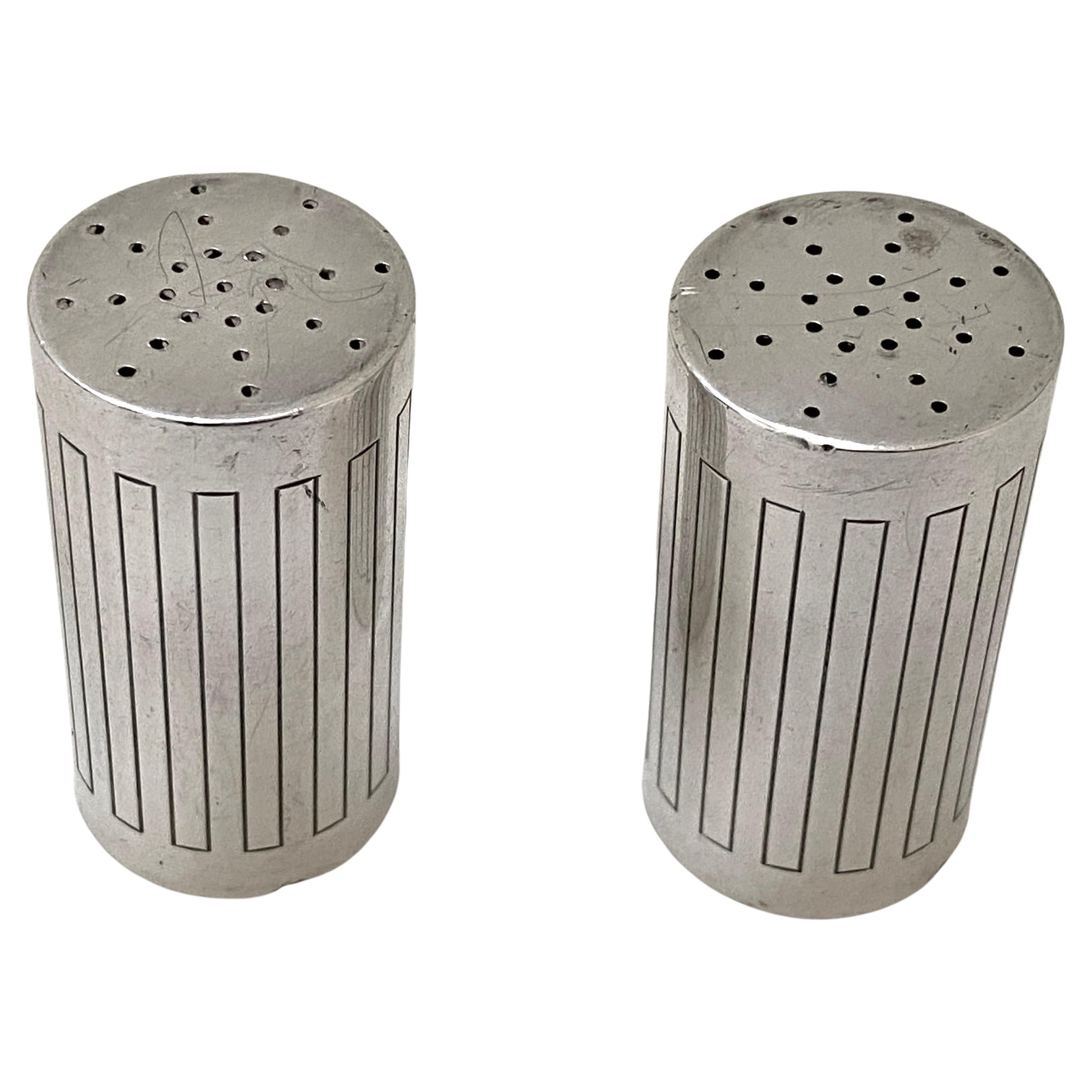This stylish set of Georg Jensen salt shakers are in the No. 902 Bernadotte pattern, and pattern was designed by Sigvard Bernadotte. 

Note: Each piece bears impressed company marks for Georg Jensen, Sterling, Denmark, Sigvard Bernadotte, 902 on the