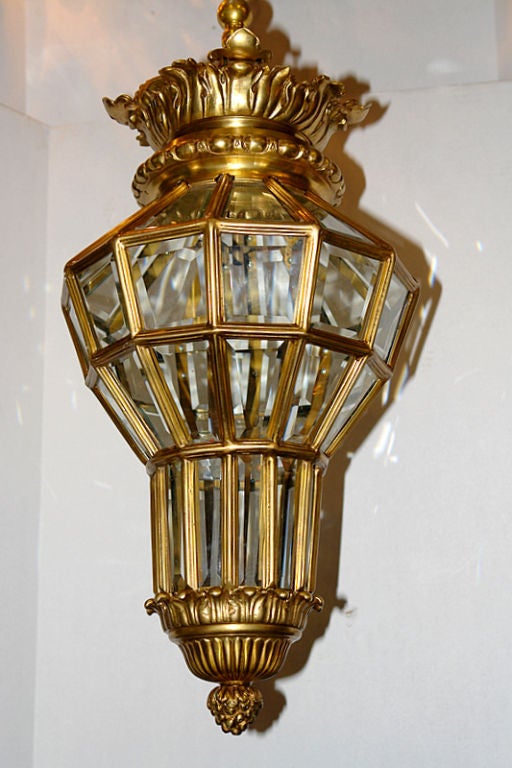 Set of seven French circa 1920s gilt bronze lanterns with beveled glass insets and original finish. Sold individually.

Measurements:
Height of body 25