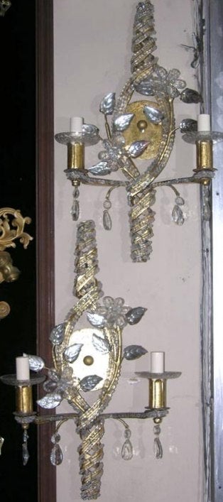 Set of six gilt metal double-light sconces with crystal beading on a spiraling frame, crystal flowers, and mirrored molded glass leaves. Sold in pairs.

Measurements:
Height: 20