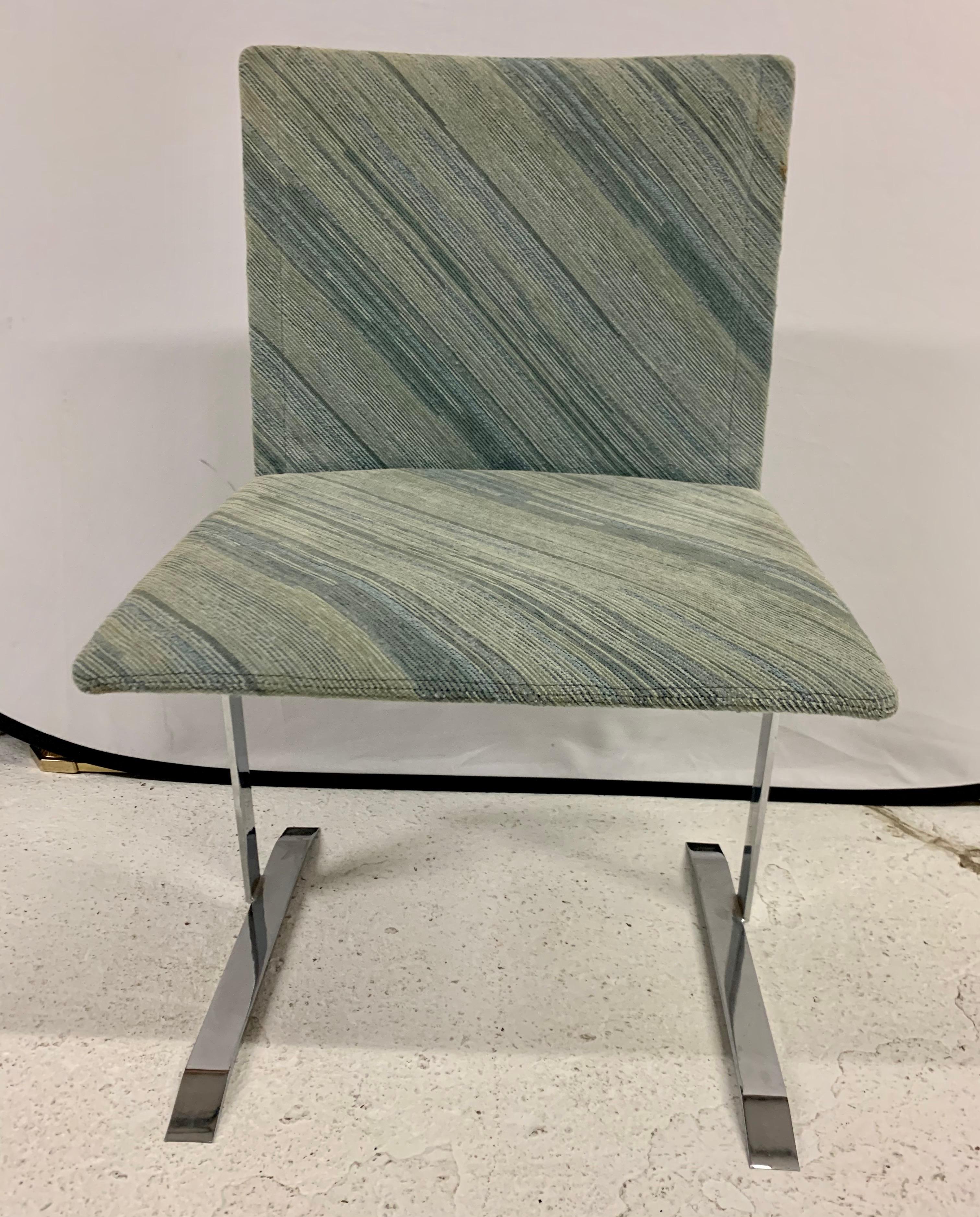 Rare Saporiti set of dining chairs with steel legs and lines to die for. These dining chairs were made in Italy and feature a seafoam, green and blue color scheme on the seat fabric. Designed by Giovanni Offredi. Circa 1970's.