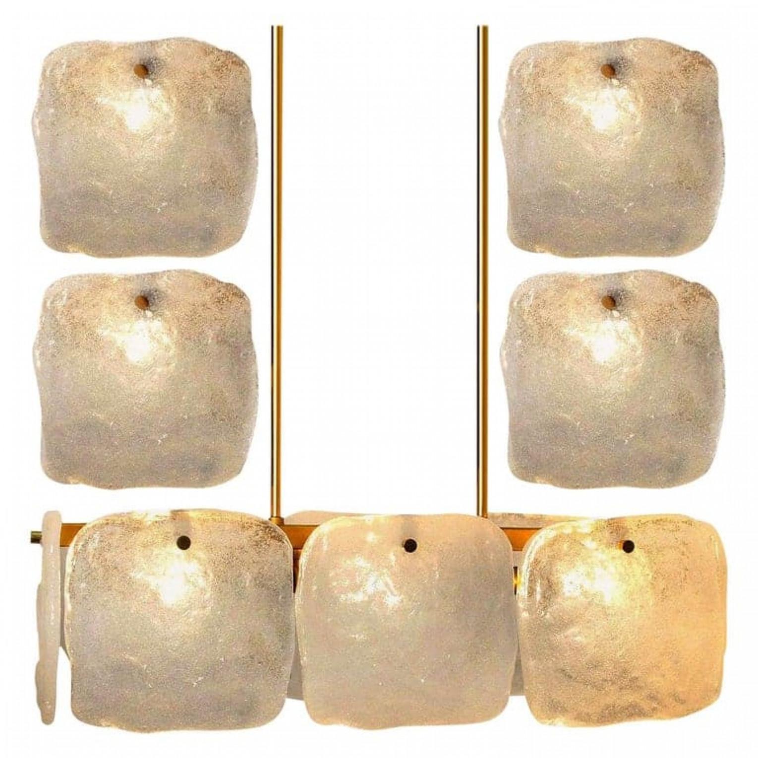 A stunning set of light fixtures designed by J.T Kalmar, manufactured by Kalmar Franken, Austria in the 1960s.
High-end and handmade design from the 20th century. The large squares of white, opaque textured glass shades (each approximately 17cm x