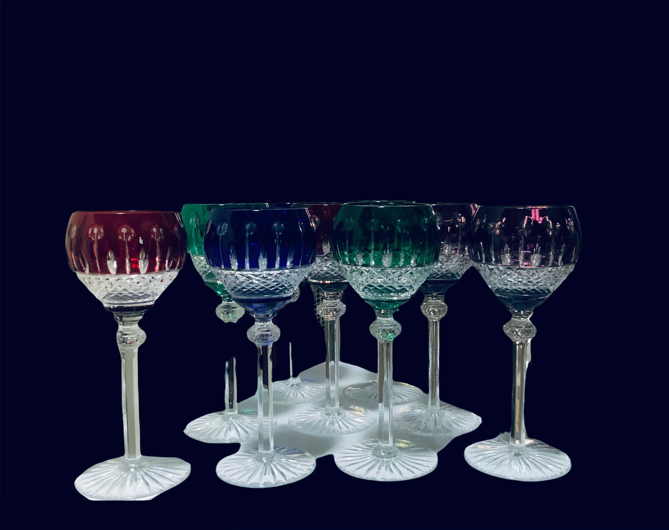 This is a set of nine Godinger King Louis pattern clear to color cut crystal hock wine round glasses. Their colored bowl is adorned with “feathers” alternated with “lollipops”. Below it, there is a cut clear crystal strawberry diamonds pattern.