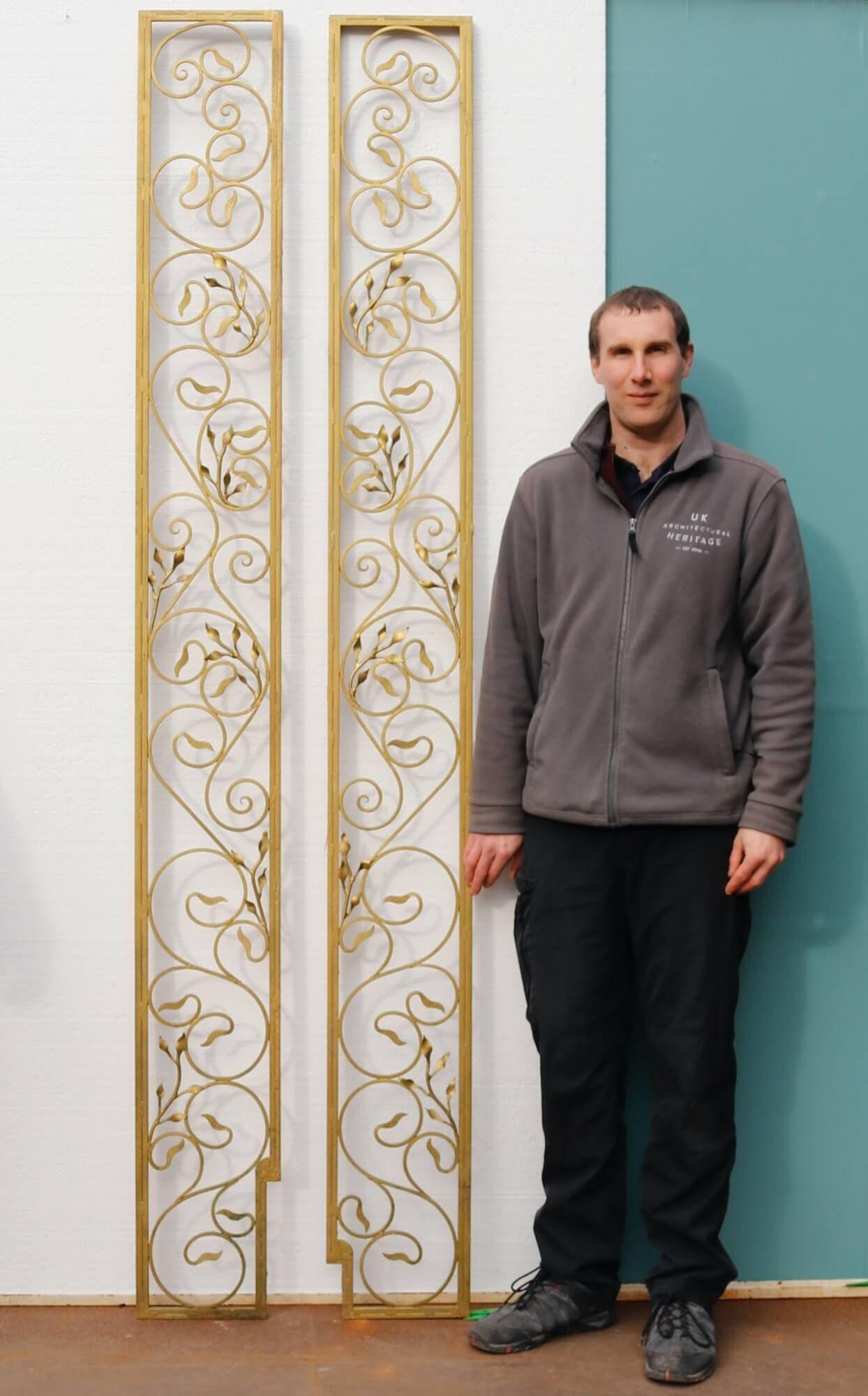 With their painted gold finish and ornate design, this pair of tall Hollywood Regency style decorative wrought iron panels make a beautiful feature in a garden. Dating from the mid 20th century, each decorative garden panel is beautifully