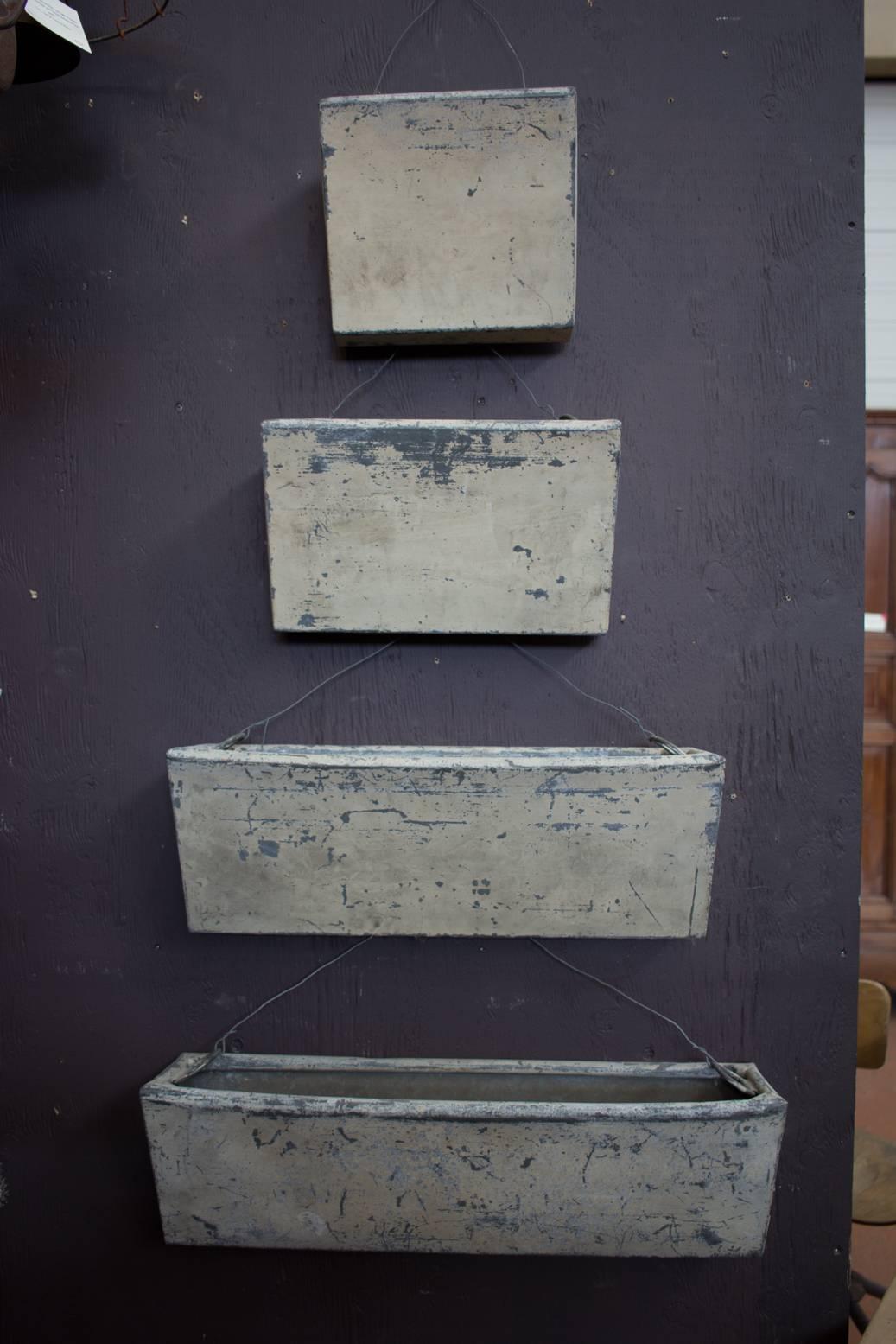 Rare set of original French zinc graduated planters. Very substantial with beautiful original buttery paint colour.

Dimensions are of how we have them set up in the pictures.
Individual lengths: 26.0