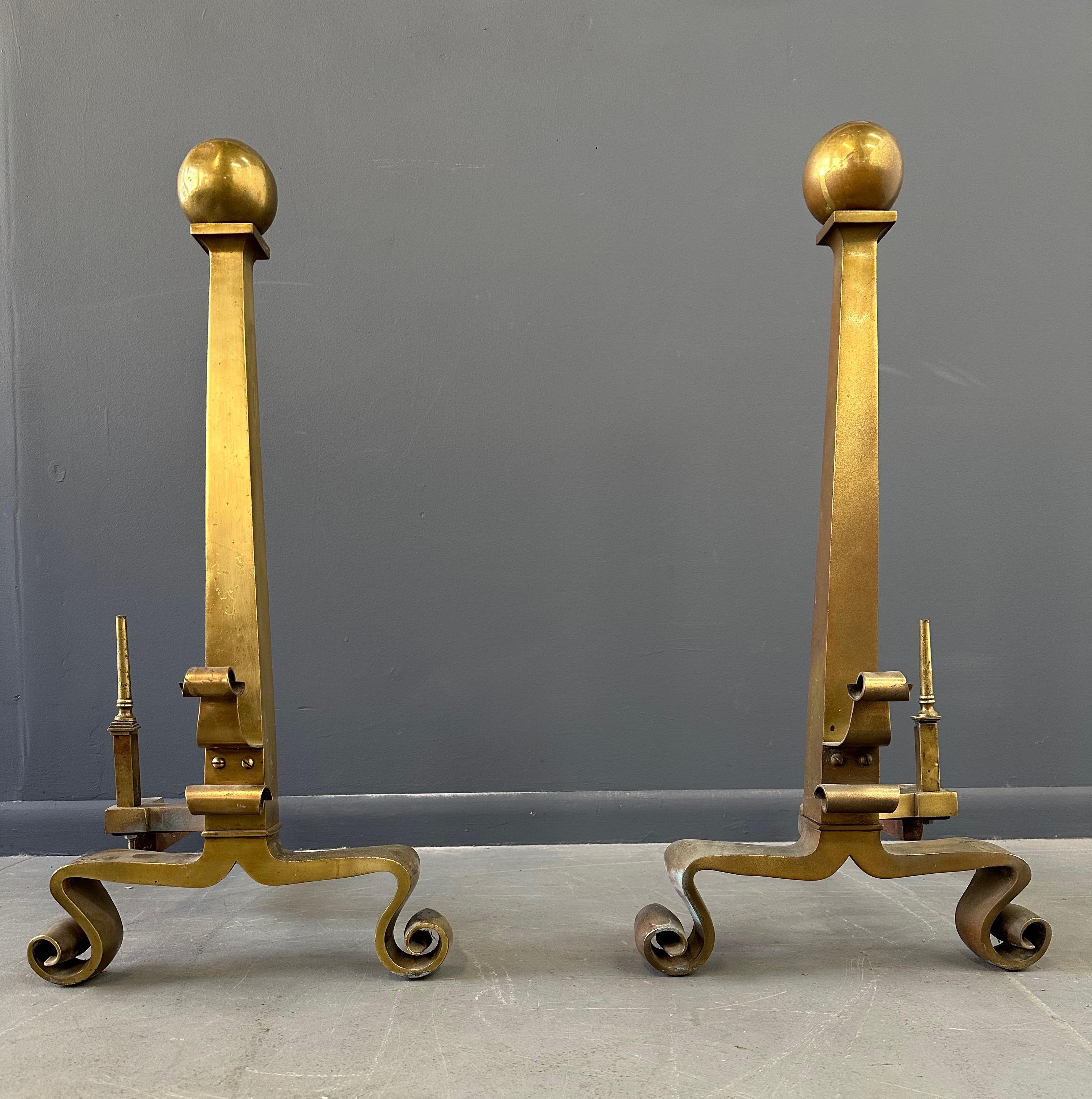 Expertly crafted and elegantly designed, this set of Grand Antique Brass Columnar Andirons with Cannonball Finial will add a touch of sophistication to your fireplace. Made from high-quality brass, these andirons offer both style and functionality,