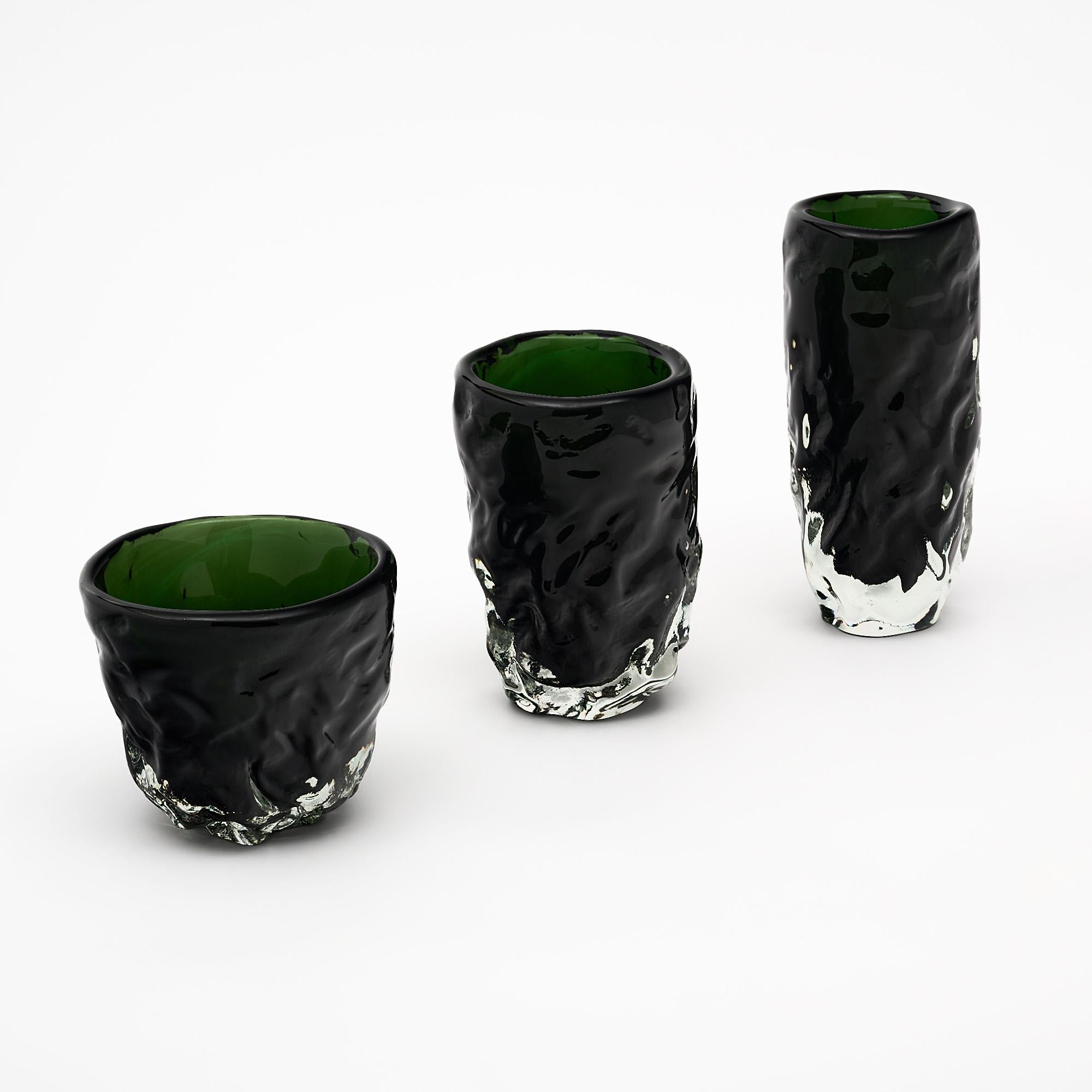 Set of three vases from the Island  of Murano outside of Venice; Italy. They are hand blown in a deep green and clear colored glass. The organic shape is an homage to Alberto Burri. Created and signed by Alberto Dona.

Tall Vase
H: 16”
D: