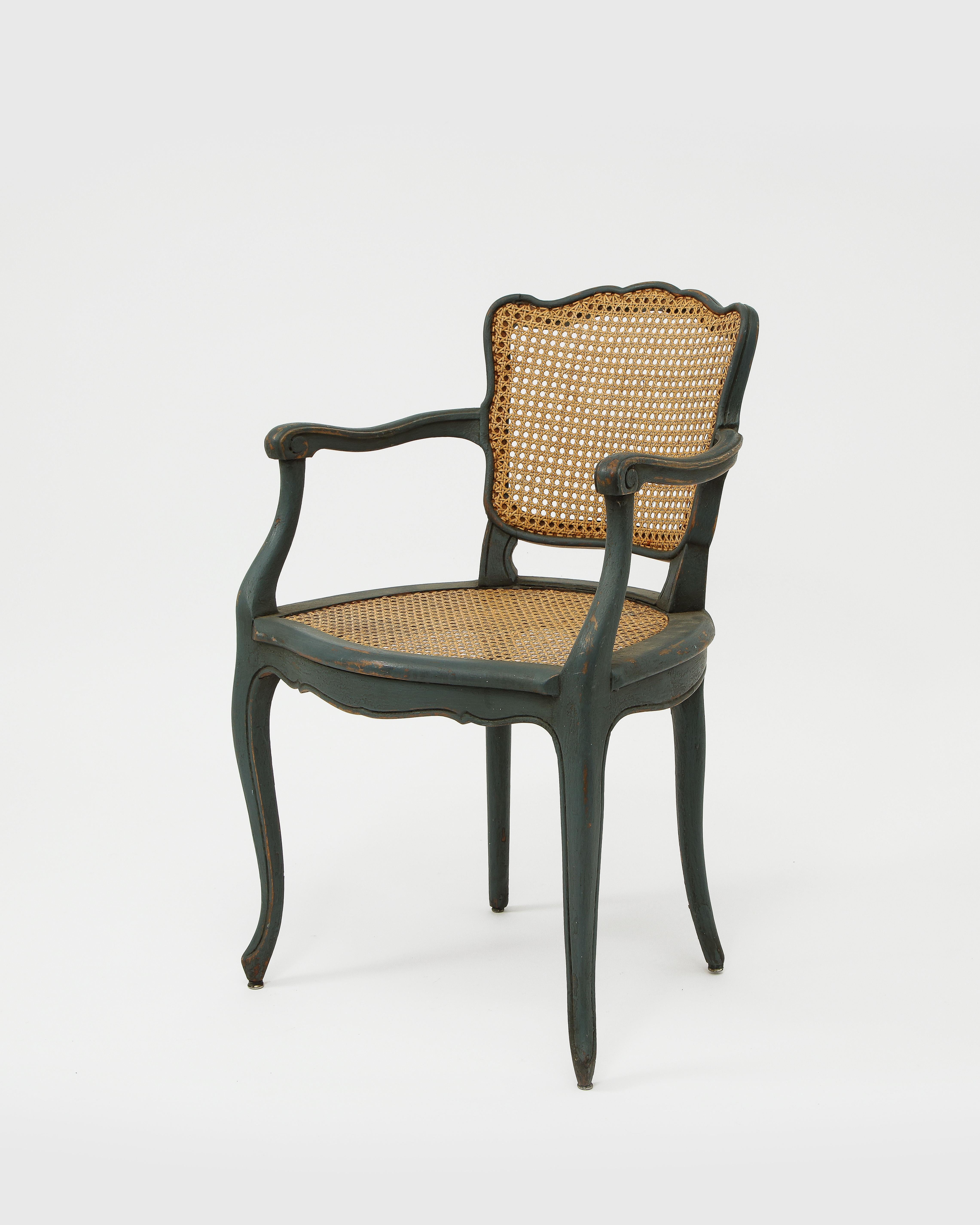 Sinuous lines in the French Provincial tradition. Matte hand painted finish in an extraordinary grey green paint. Custom cushions can be made to fit these chairs.

Several of the caned panels require restoration. Some joints may require