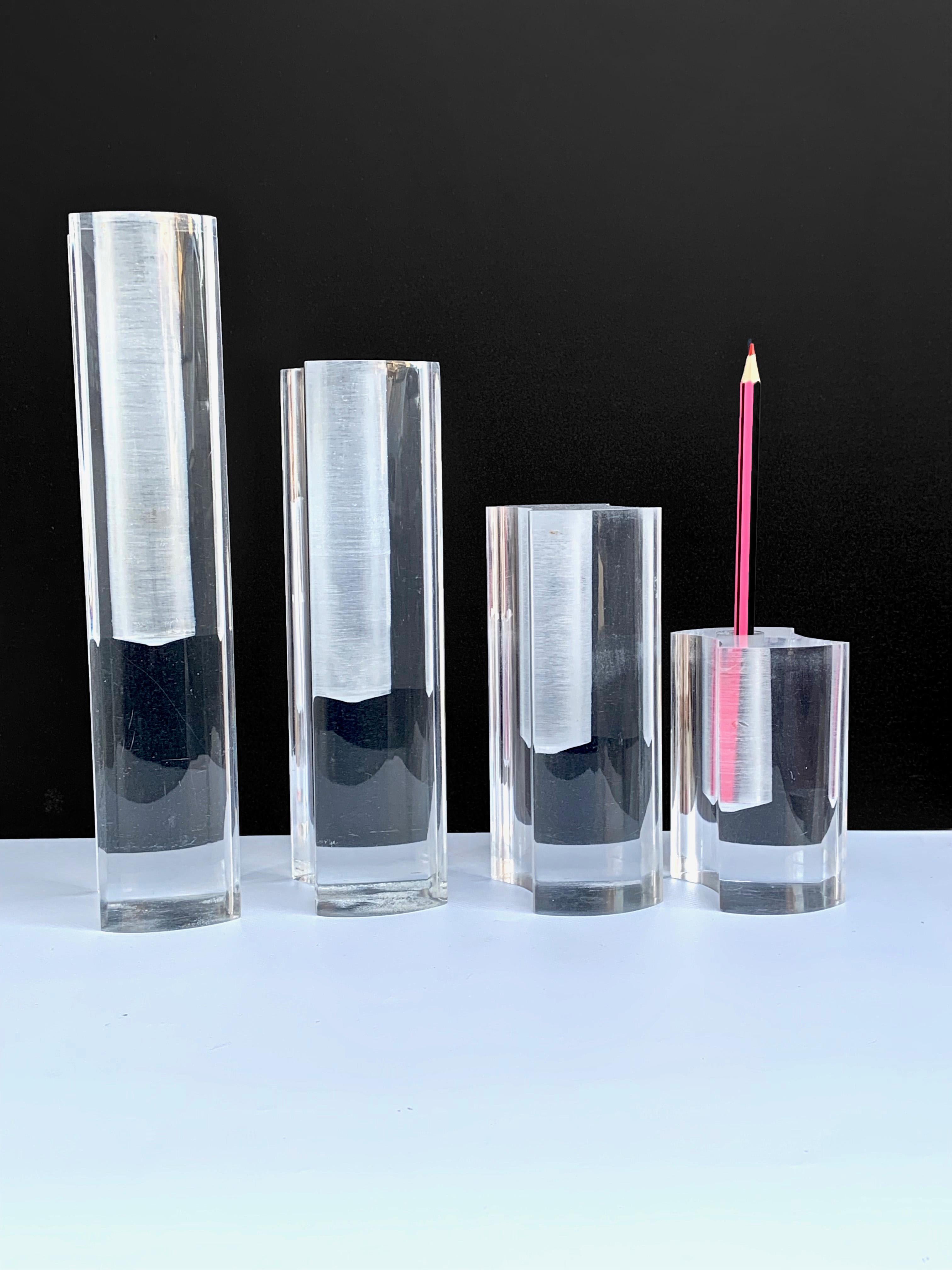 Set of four wonderful plexiglass midcentury crystal plexiglass Italian vases. These pieces were produced by Guzzini in Italy during 1970s.

The set, with the four vases one close to the other, creates a mesmerizing effect due to proportions and