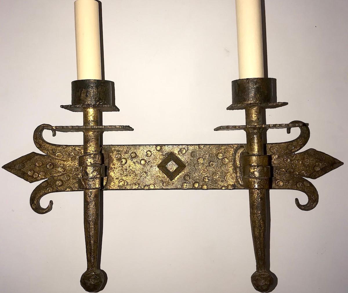 A set of 12, circa 1940s Spanish hammered wrought iron sconces with original gilt finish.

Measurements:
Height 11