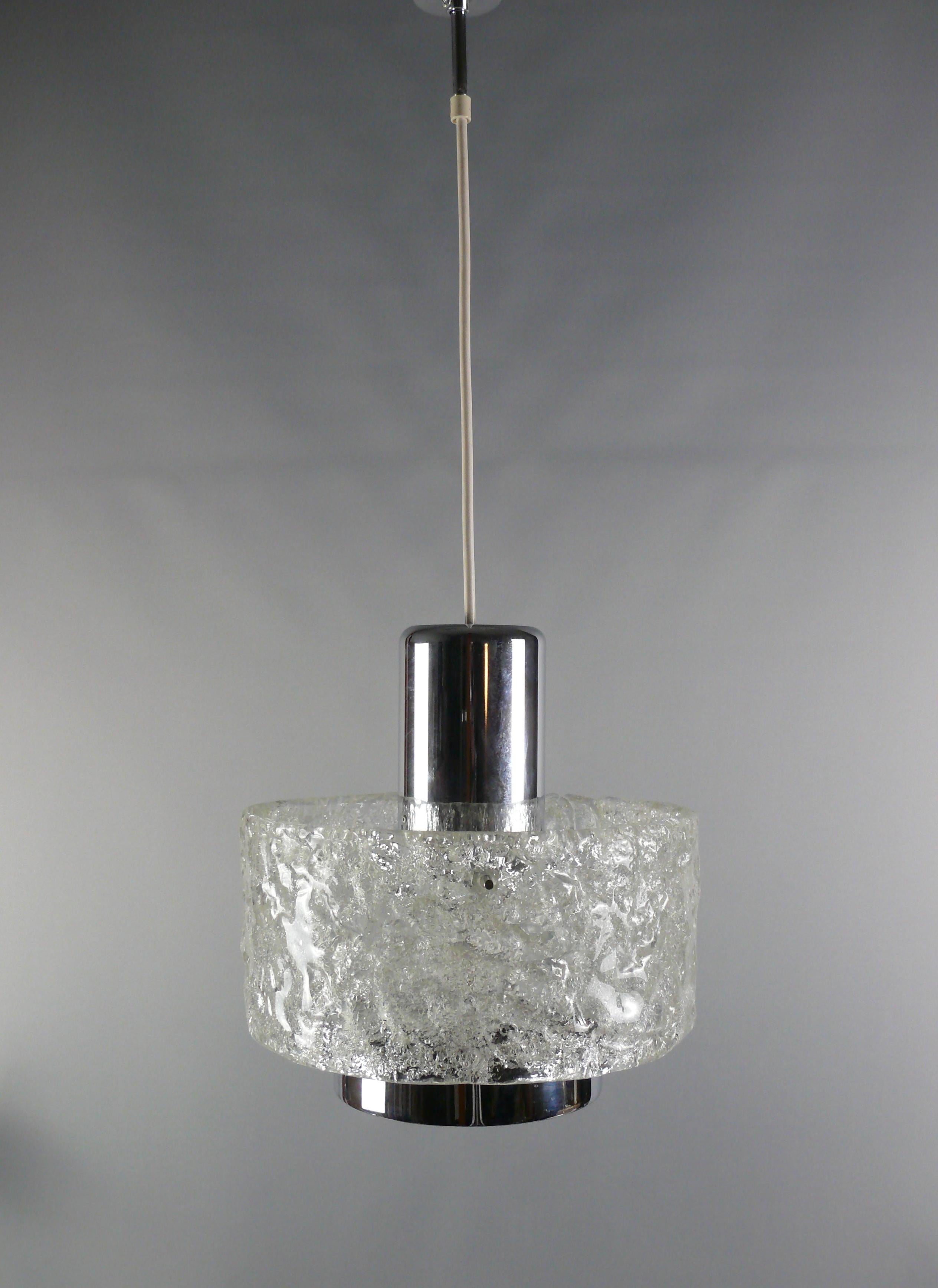 Very rare set of iceglass lamps made by Egon Hillebrand in Germany in the late 1960s. The pendant lamp consists of a large ice glass ring that is held by an elaborate chrome-plated suspension. The glass shade is attached to the suspension with three