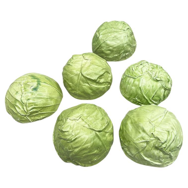 A set of seven green Hollywood Regency ceramic lettuceware or cabbageware bowls and a matching serving plate (In the manner of Dodie Thayer). This set includes six bowls and one serving platter. The entire set is created from ceramic and features a