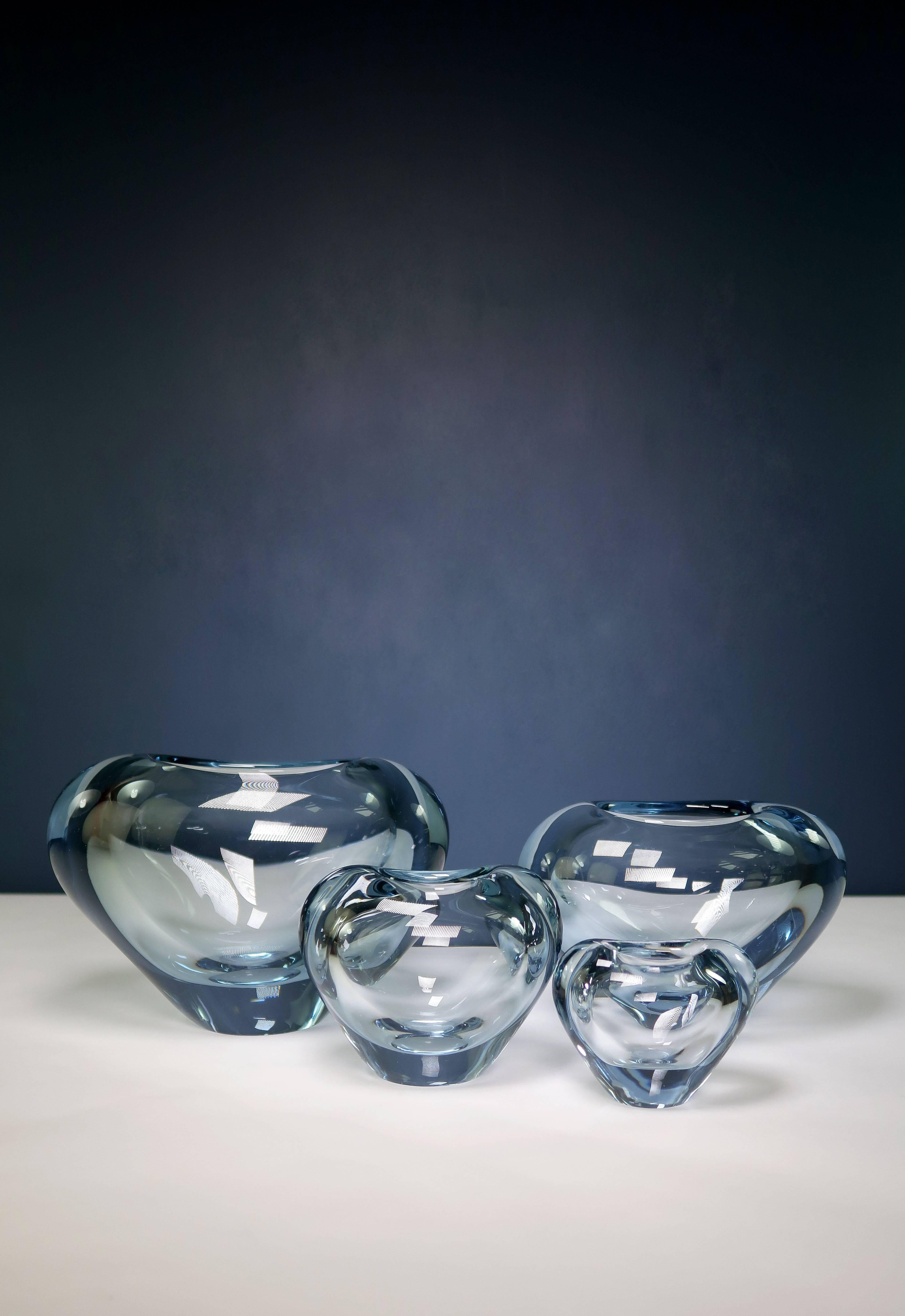 Four Danish Mid-Century Modern heart shaped vases in light blue hand blown art glass. All vases are intact and in beautiful and color-bright condition. By designer and artistic manager of Holmegaard Per Lütken (1916-1998). Manufactured in the