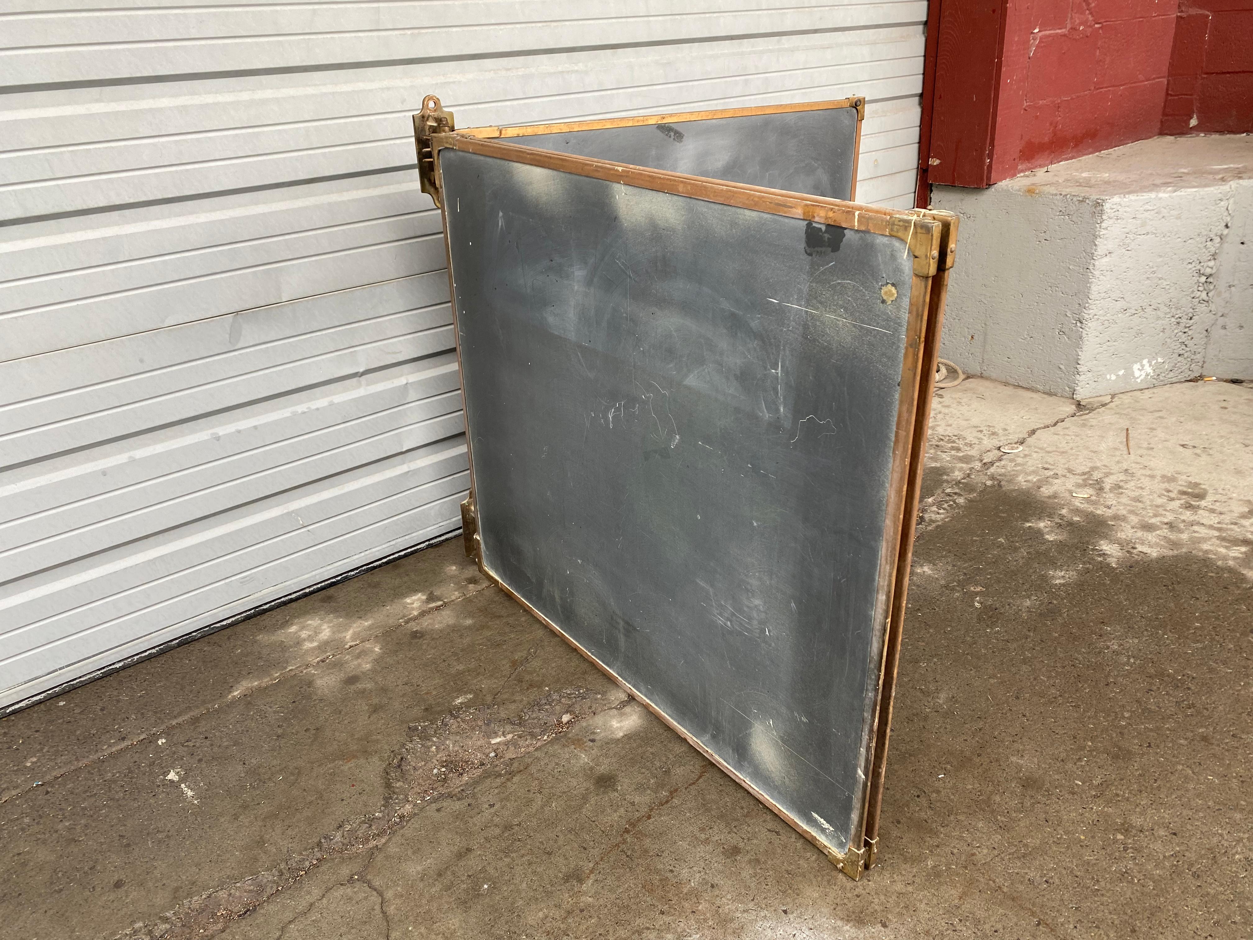 An outstanding set of antique slate chalkboards in their original frames with bronze corners, along with the bronze wall mounted brackets that hold them all and allow them to pivot to use both sides of the boards. Beautiful set in very good