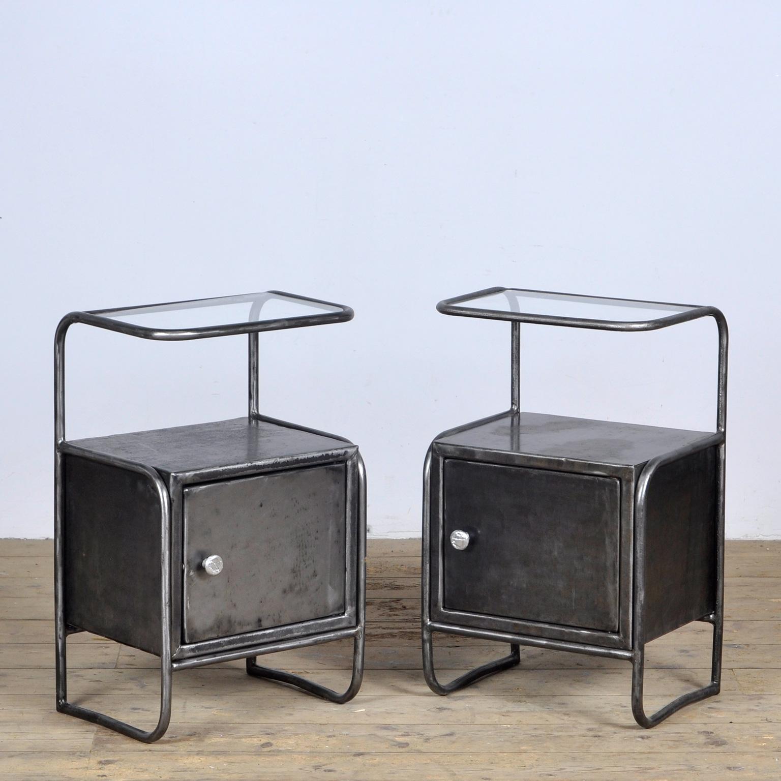 Set of iron bedside tables with a glass top, circa 1950. The cabinets originally came from a hospital. They have been stripped of the paint and polished. Treated against rust.