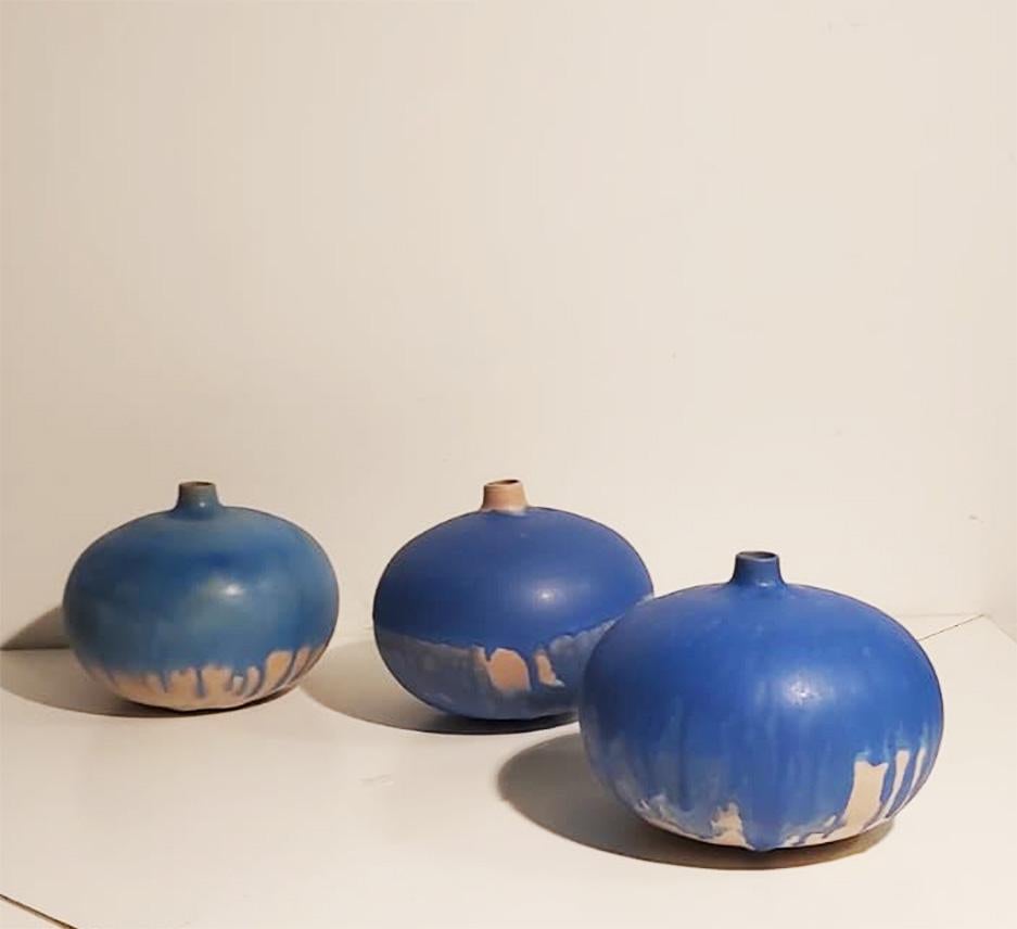 Set of three vases with three different blue nuances,
 with shape of flattened sphere and small elegant top opening.
Signed under the base

Measure: diameter 19 cm.