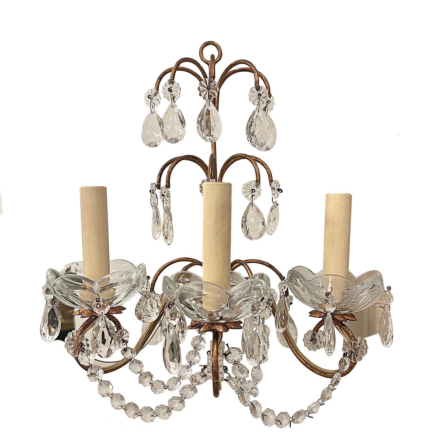 Set of eight gilt metal three-arm sconces with crystal drops and pendants, with original patina.

Measurements:
Height: 17