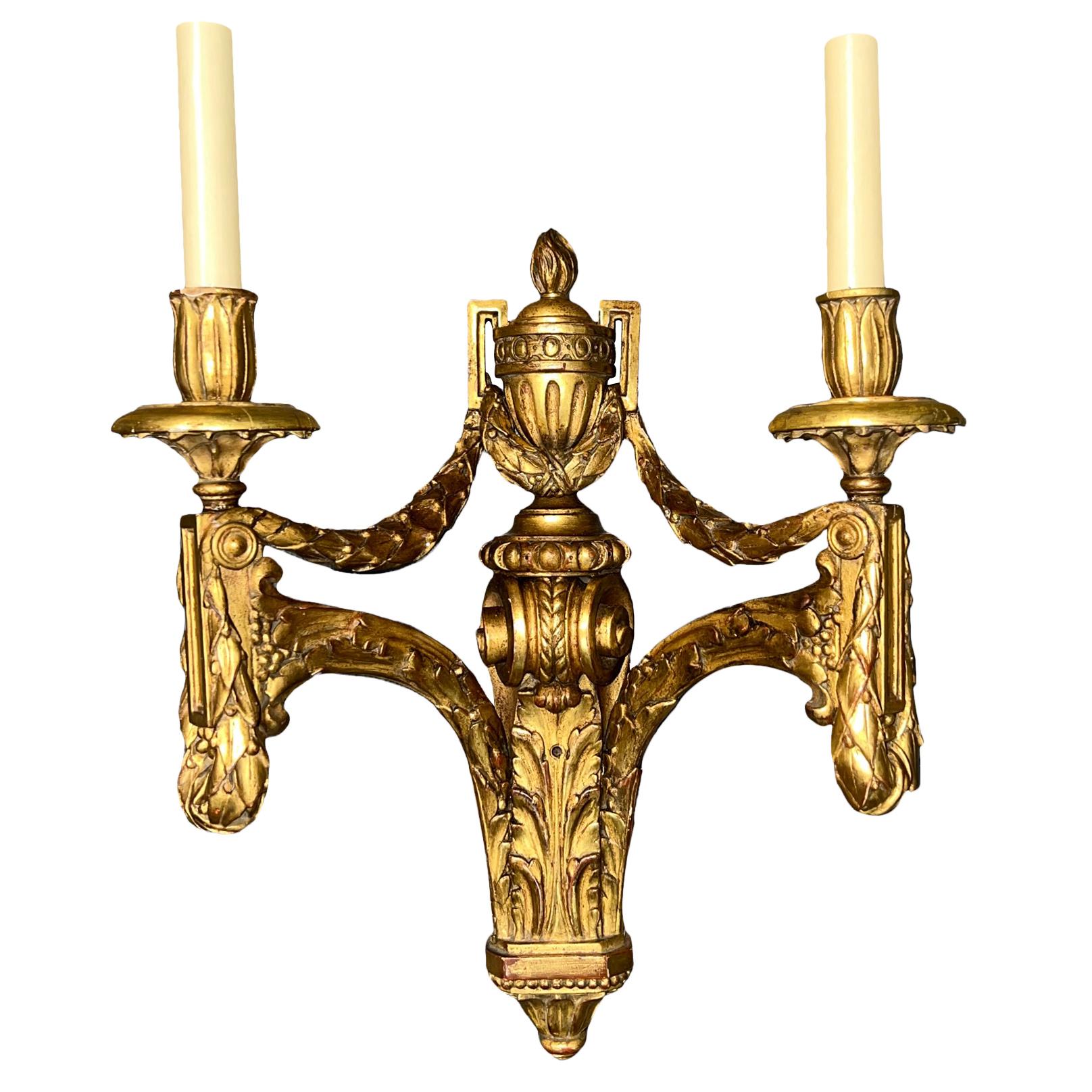 A set of four circa 1900's Italian carved and gilt wood sconces. Sold in pairs.

Measurements:
Height: 18