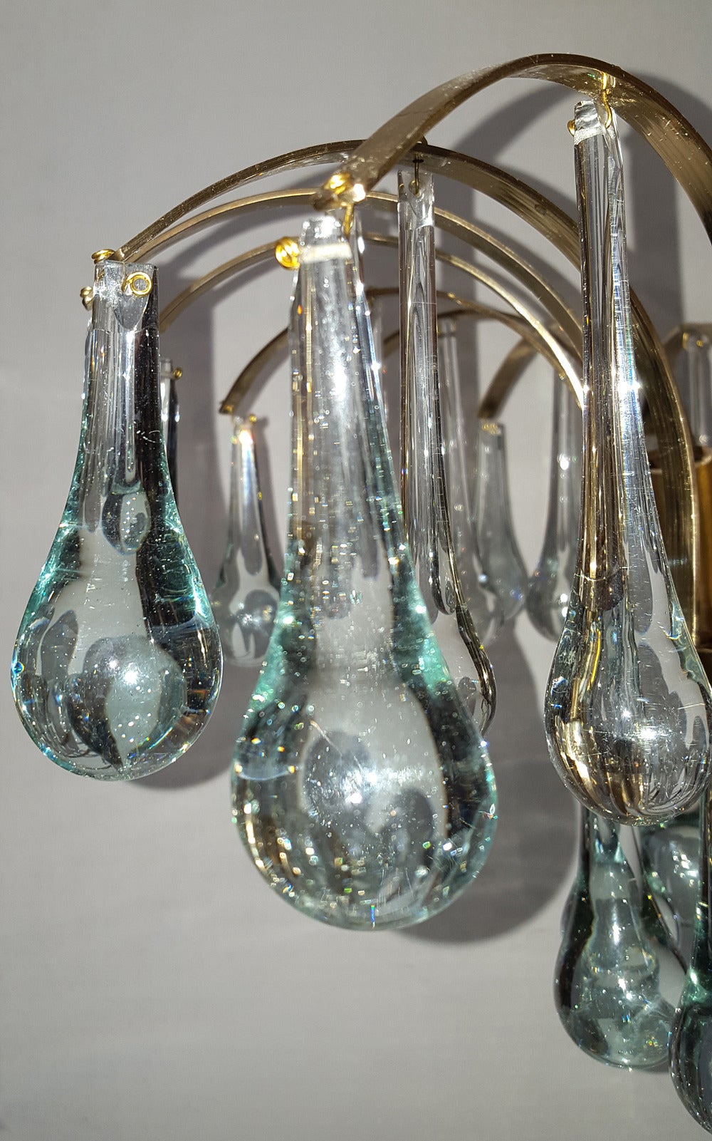 A set of twelve circa 1960s Italian moderne-style flush-mounted light fixtures with glass drops and four interior candelabra lights each. Sold individually.

Measurements:
Diameter 17