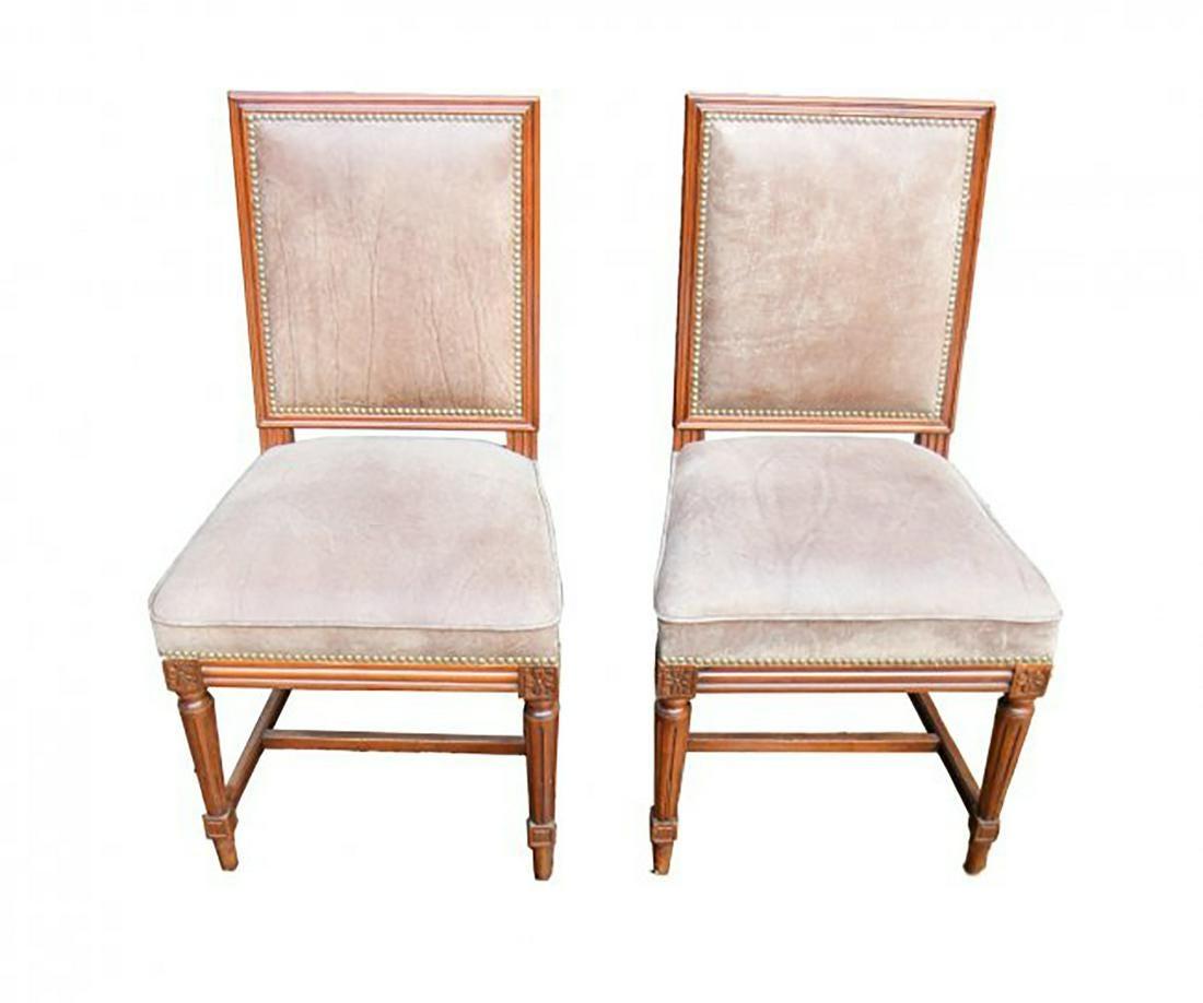 Set of Jansen manner Louis XVI style walnut wood dining side chairs with distressed brown leather seats and backs.