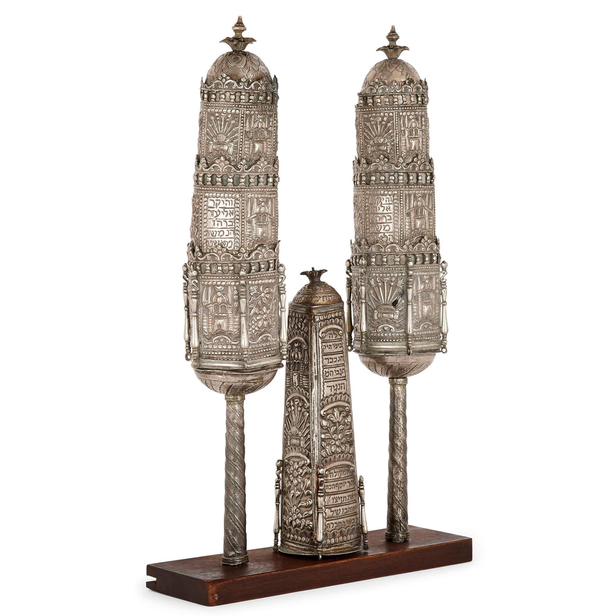 Set of Judaica silver Rimonim (Torah finials)
Middle-Eastern, c.1800
Pair: height 46cm, diameter 8cm
Single: height 24cm, diameter 17cm
Weight approximately 1,500 grams

In a tiered, hexagonal form, with galleries of balustrades, these fine