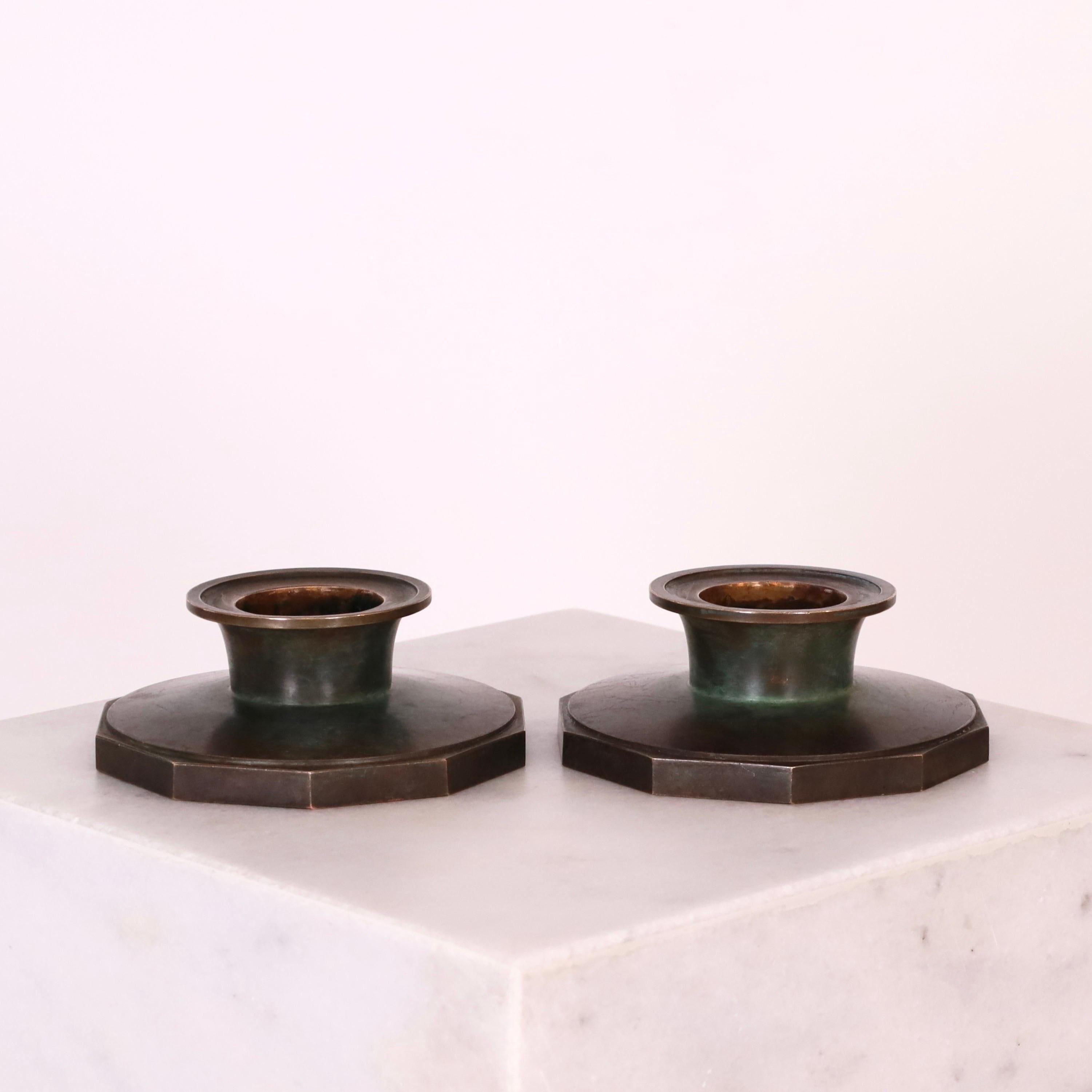 A set of subtile bronze candle holders designed by Just Andersen in 1934. 

* A set of small 10-sided bronze candle holders
* Designer: Just Andersen
* Manufacturer: Just Andersen
* Style: B1607
* Year: 1934
* Condition: Good vintage condition with