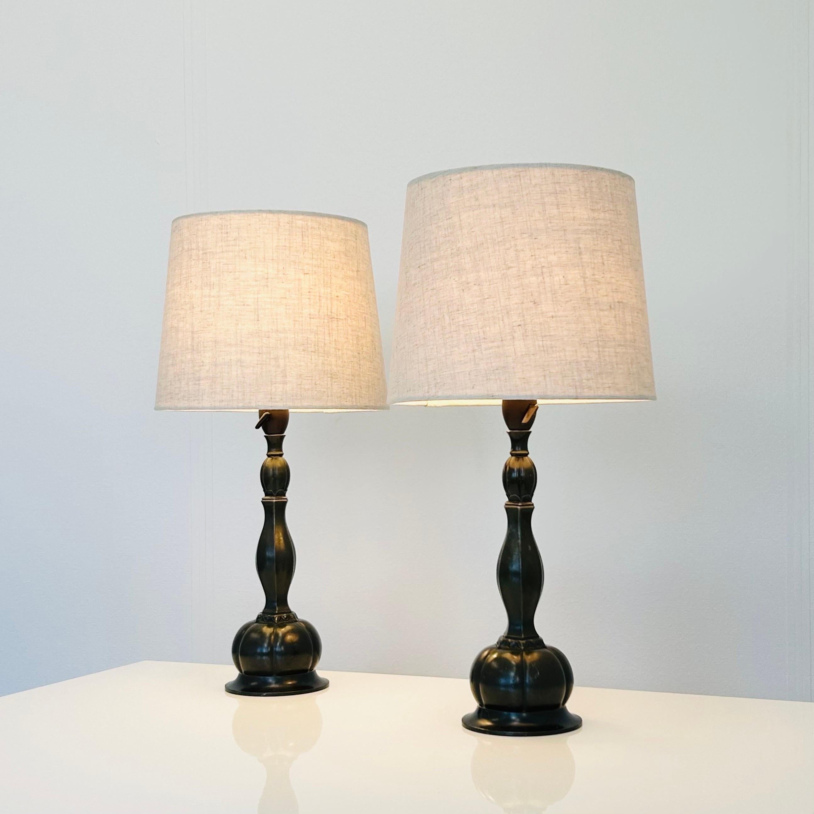 An exquisite set of early Just Andersen table lamps.

Crafted from Disko metal, an alloy invented by the Danish designer himself, these lamps exude a unique and timeless charm. Engraved with 'Just D60' model number, these lamps were created