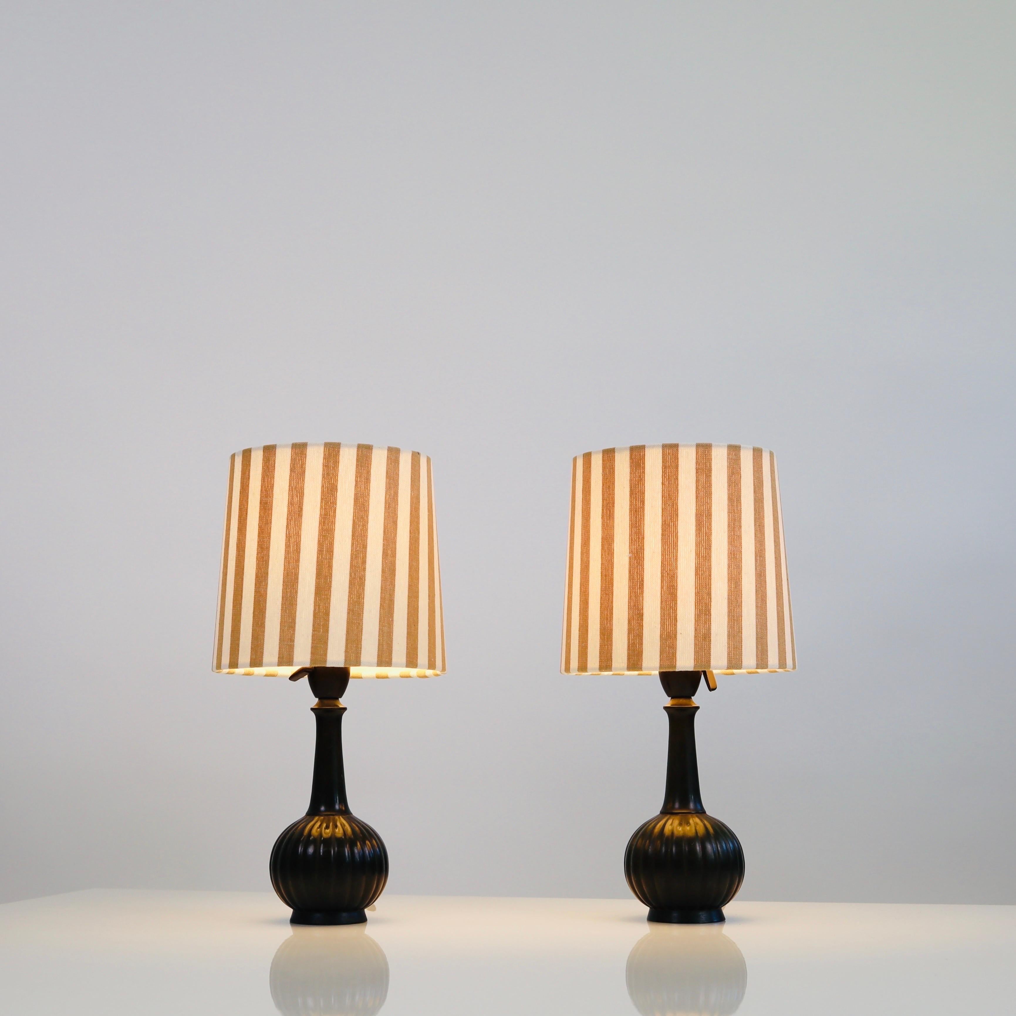 A set of Just Andersen table lamps made in the 1920s and accomplished with new shades made of artisan textile from Mallorca. A rare, exquisite set closing in on a 100 years of life-time.

* A set of metal desk lamps with a round base with vertical