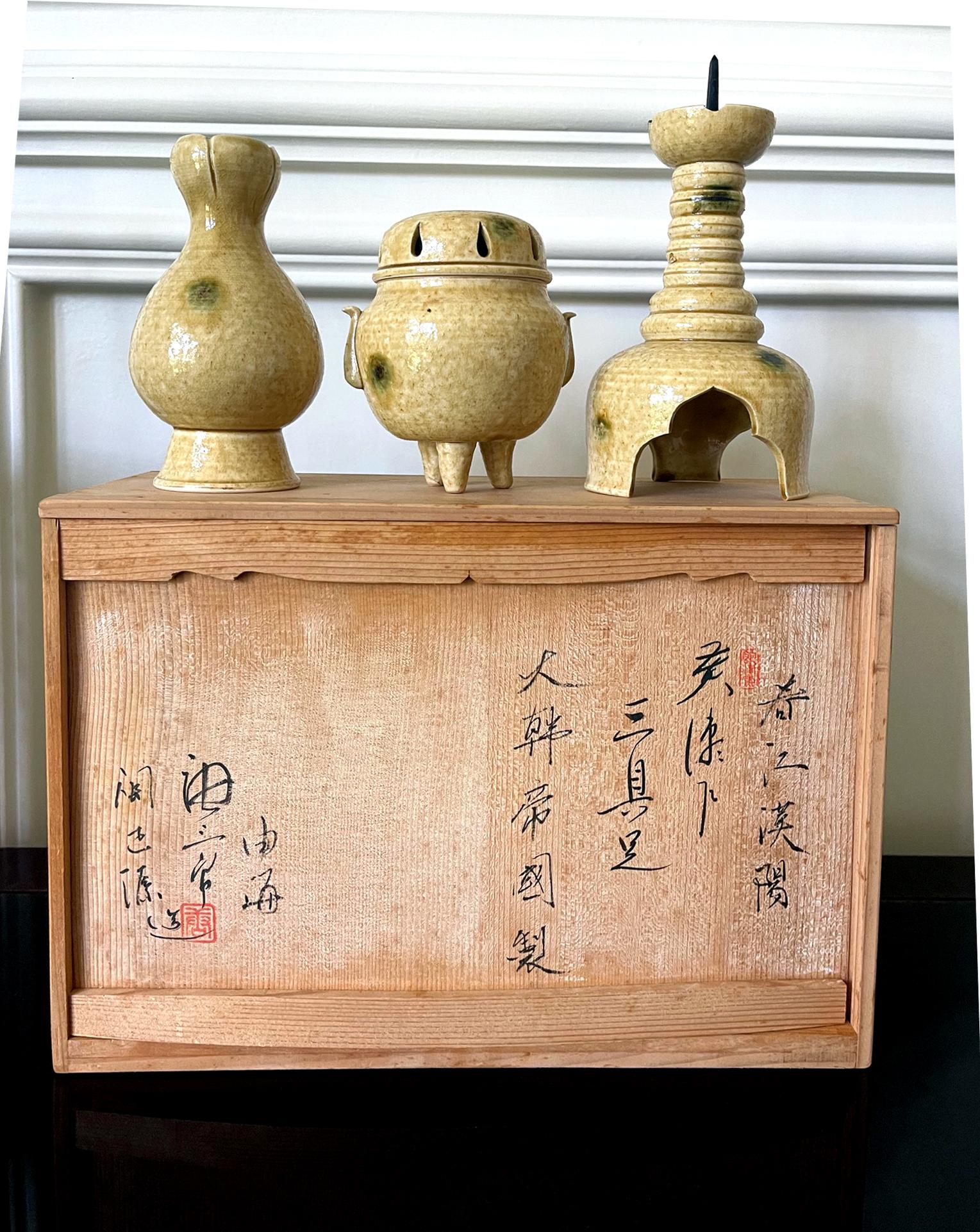 A set of three ki-seto (yellow-seto) ceramic altar pieces made in the period of Korean Empire (1897-1910), a short independent period after Joseon dynasty before the invasion and occupation by Japan. The set consists of a candle holder with a metal