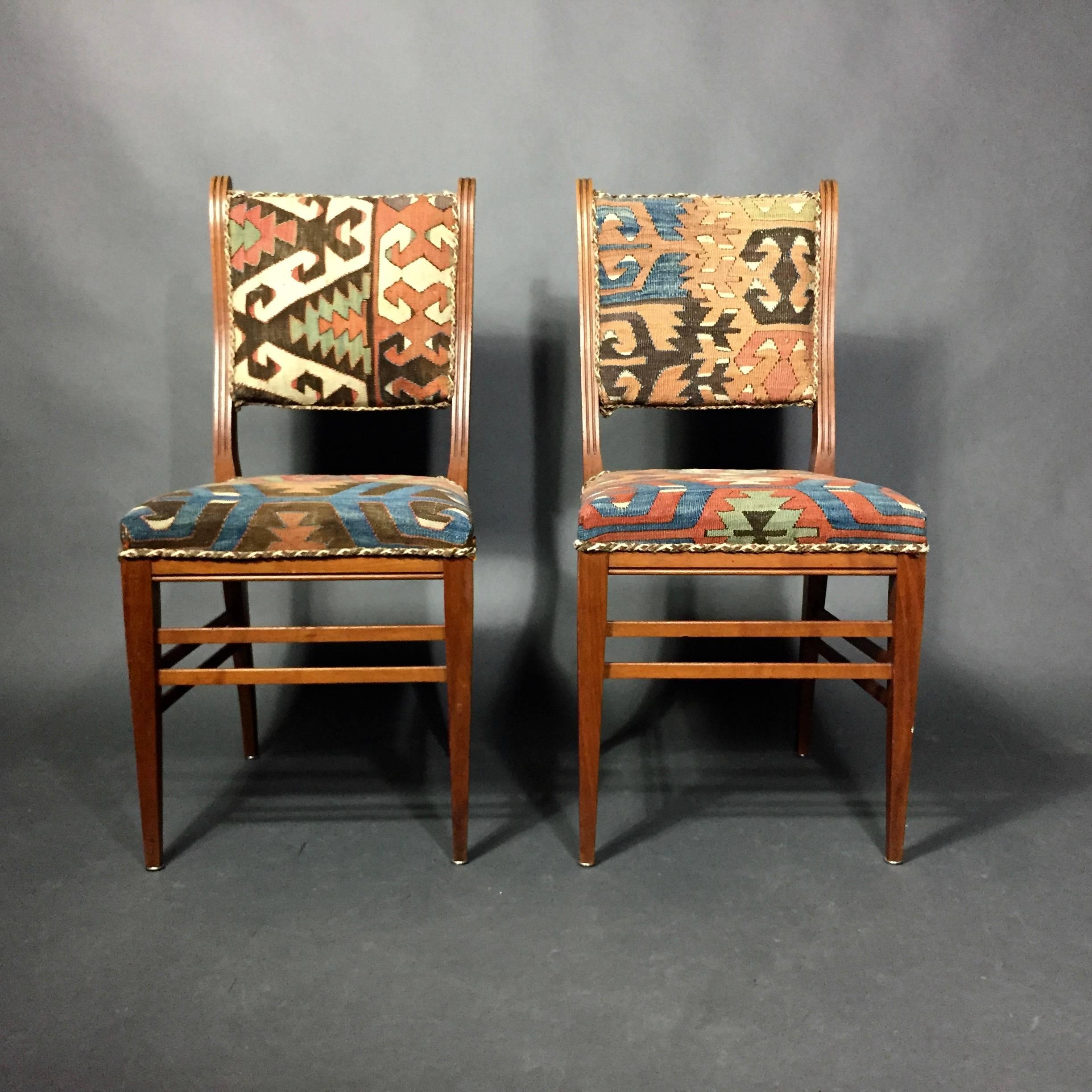 A simple viewpoint on the mahogany frame has an Art Nouveau reference in the curve and channeling of the chair back and legs, circa 1900, likely Swedish. Set updated with full upholstery of various polychrome Kilim fabric and corded piping. Very