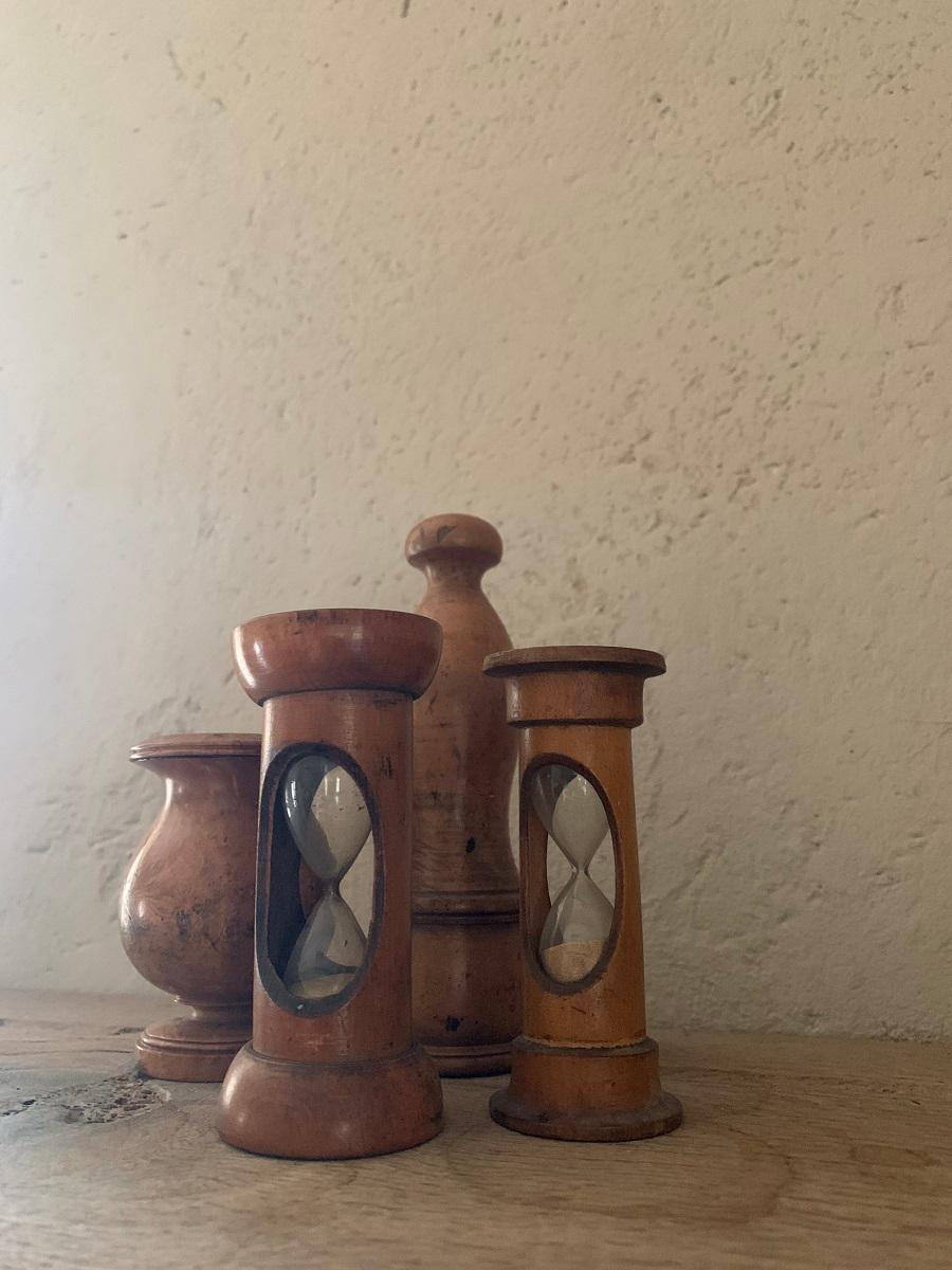 Set of kitchen treen with 2 hourglasses, one candlestick holder and pepper mill. All 19th century French.