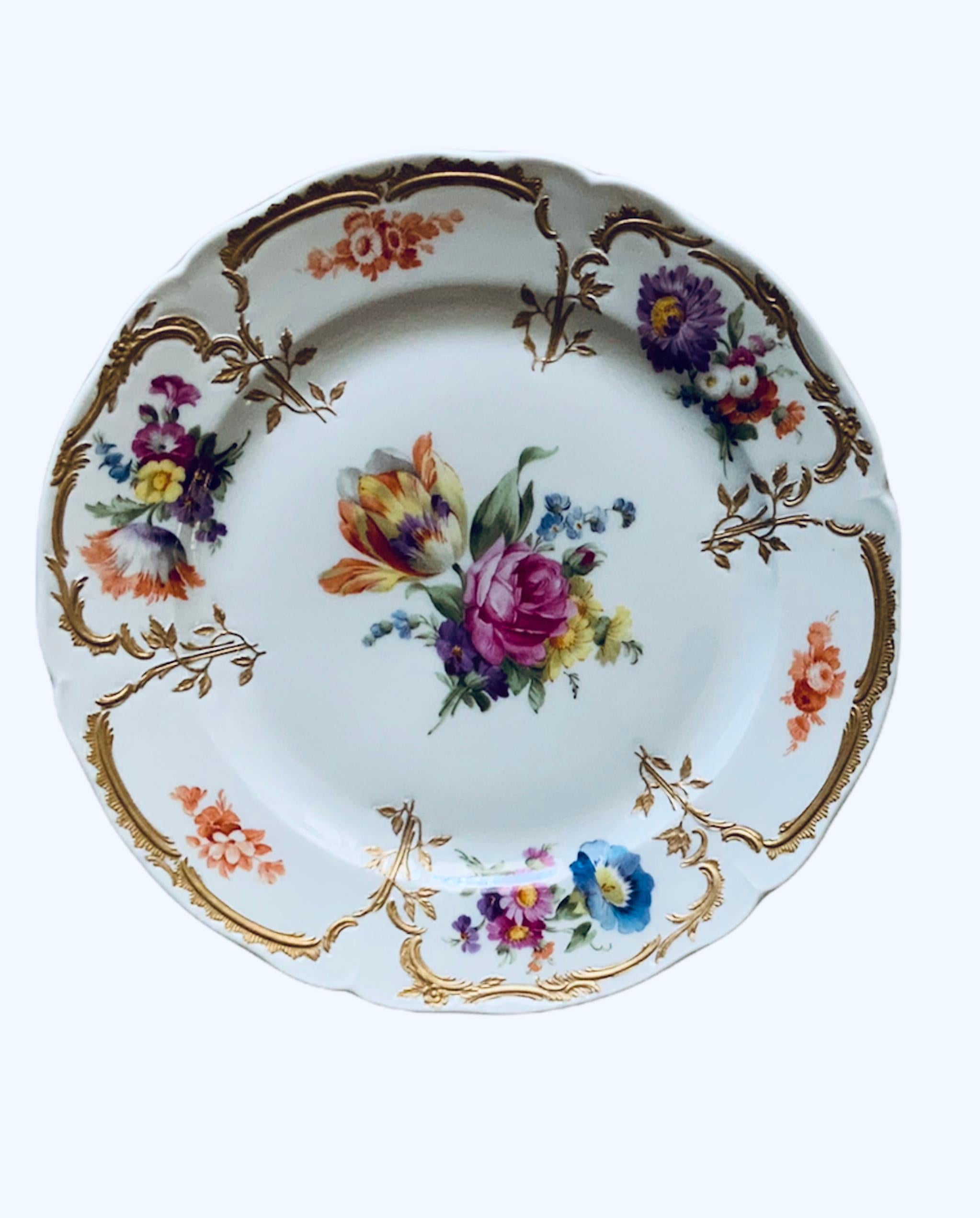 This a set of KPM Porcelain Neuzeriat plate and two small bowls. The Neuzeriat plate depicts a large bouquet of flowers in the center, then in the border there are smaller bouquets alternated with tiny bouquets flowers. This is embellished by some