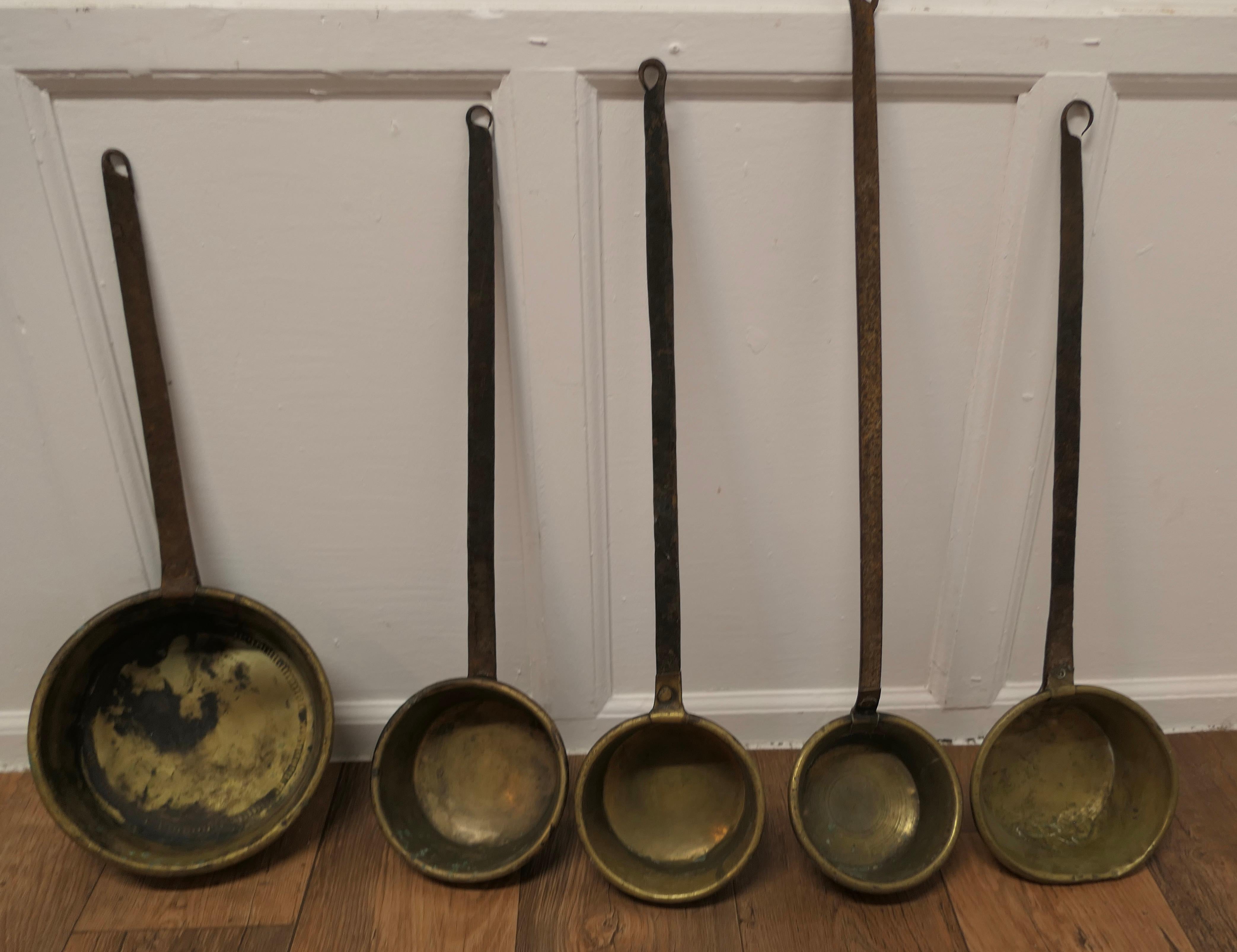 Set of Large 19th century Brass and Iron Ladles

A great set, 5 large long handle ladles, in Brass with long iron handles and in good used condition
The ladles are 25” long, the bowl of the largest one is 10” in diameter 
MS185.