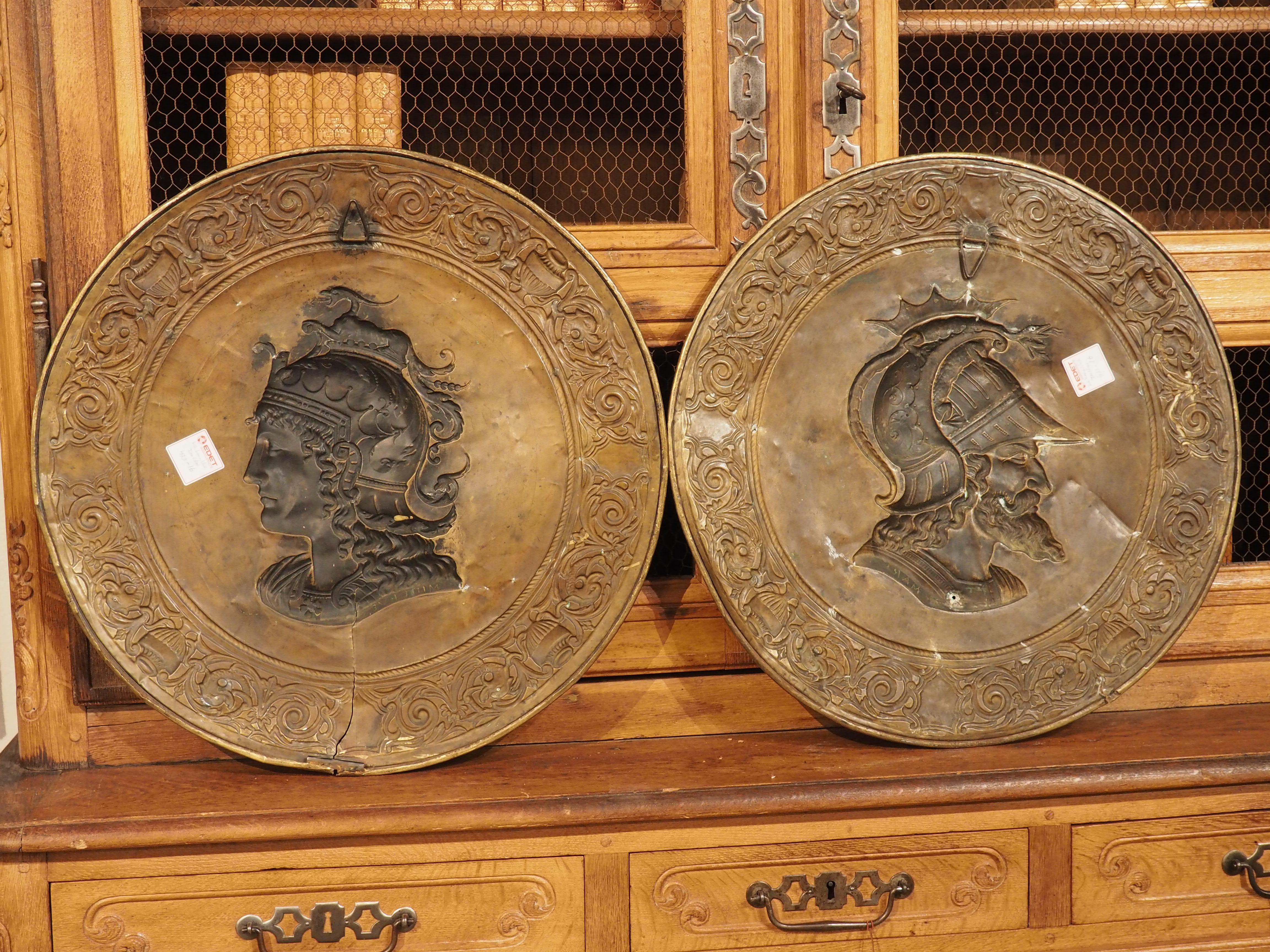 Possibly inspired by a 1771 painting by Jacques-Louis David, this set of large brass chargers depict the Roman deities, Mars and Minerva. The painting by David (Minerva Fighting Mars) is currently on display at the Louvre and was awarded second