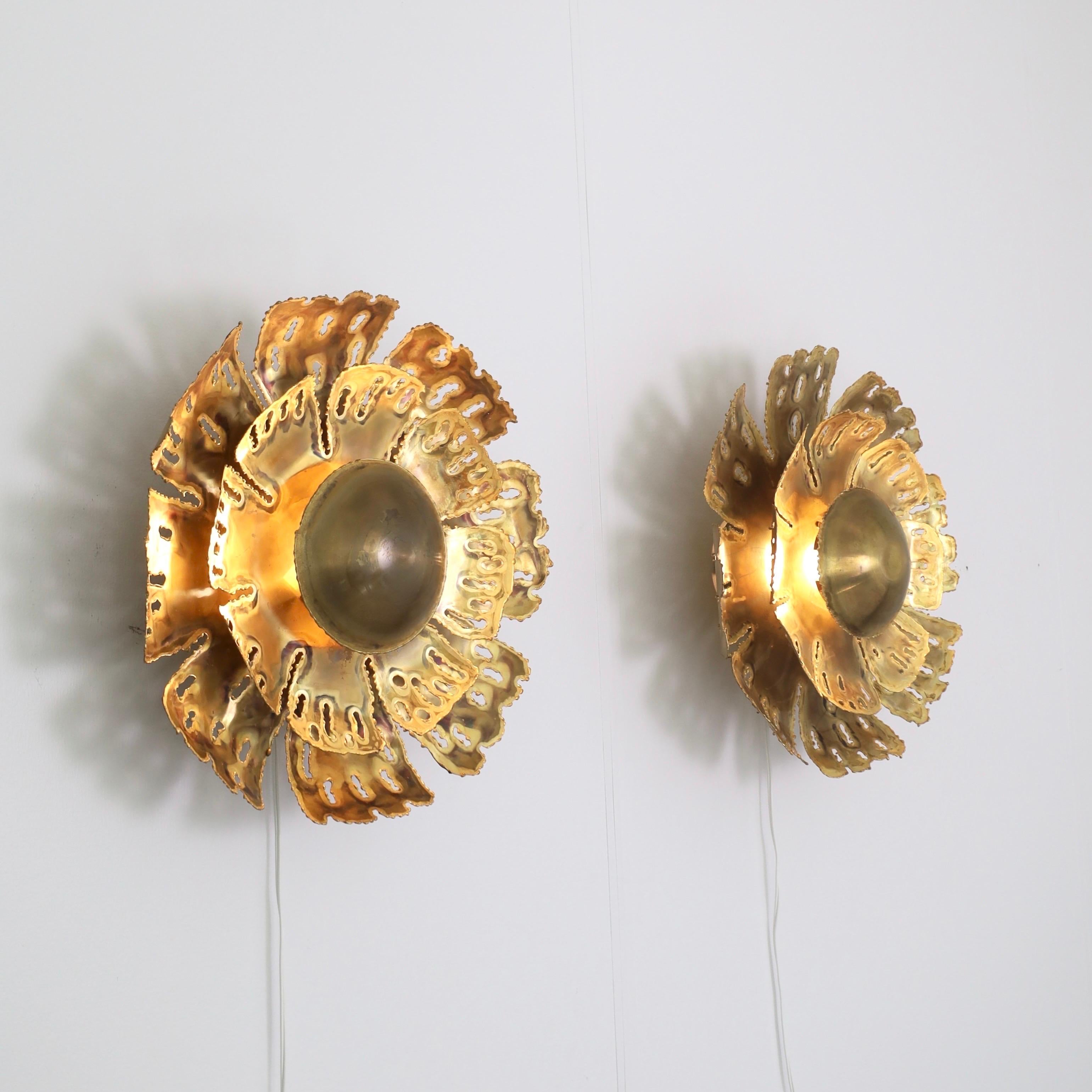 A pair of substantial sun-shaped brass wall lamps designed by Svend Aage Holm Sørensen in the 1960s. An eye-catching set for a beautiful place. 

* A pair (2) of flame-cut sun-shaped brass sconces
* Designer: Svend Aage Holm Sorensen
* Model: 5207
*