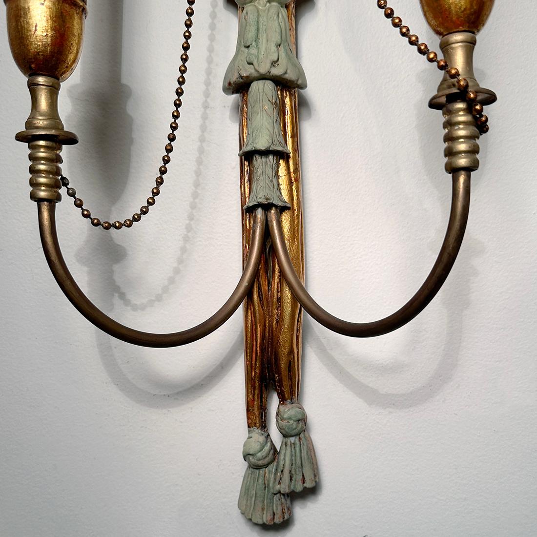 A set of four circa 1950's French gilt wood two-arm sconces with eagle crowning the bodies and original patina. Sold in pairs.

Measurements:
Height: 30