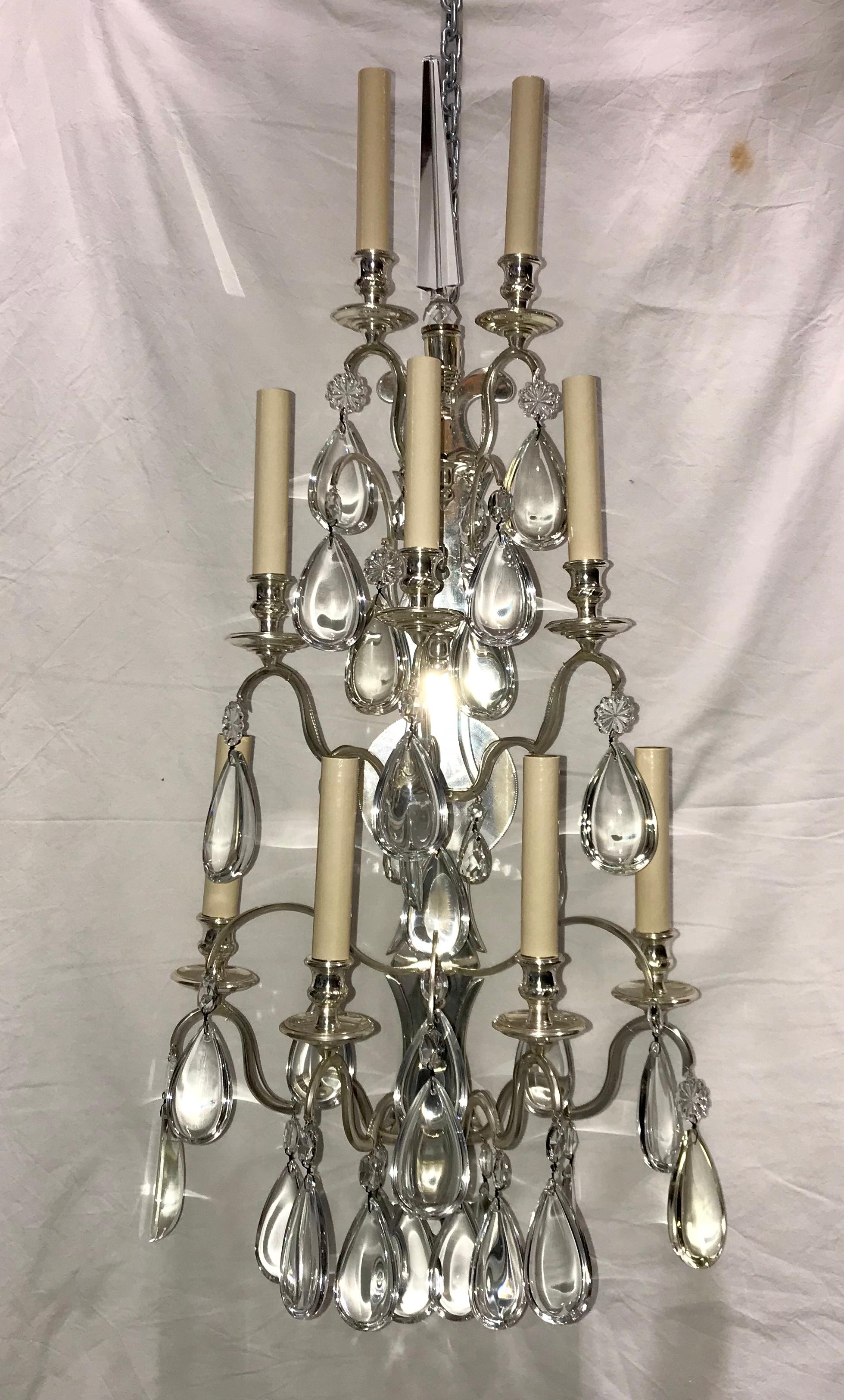 A set of four large French circa 1920's French bronze sconces with crystal drops and nine lights each. Sold per pair.

Measurements:
Height: 38