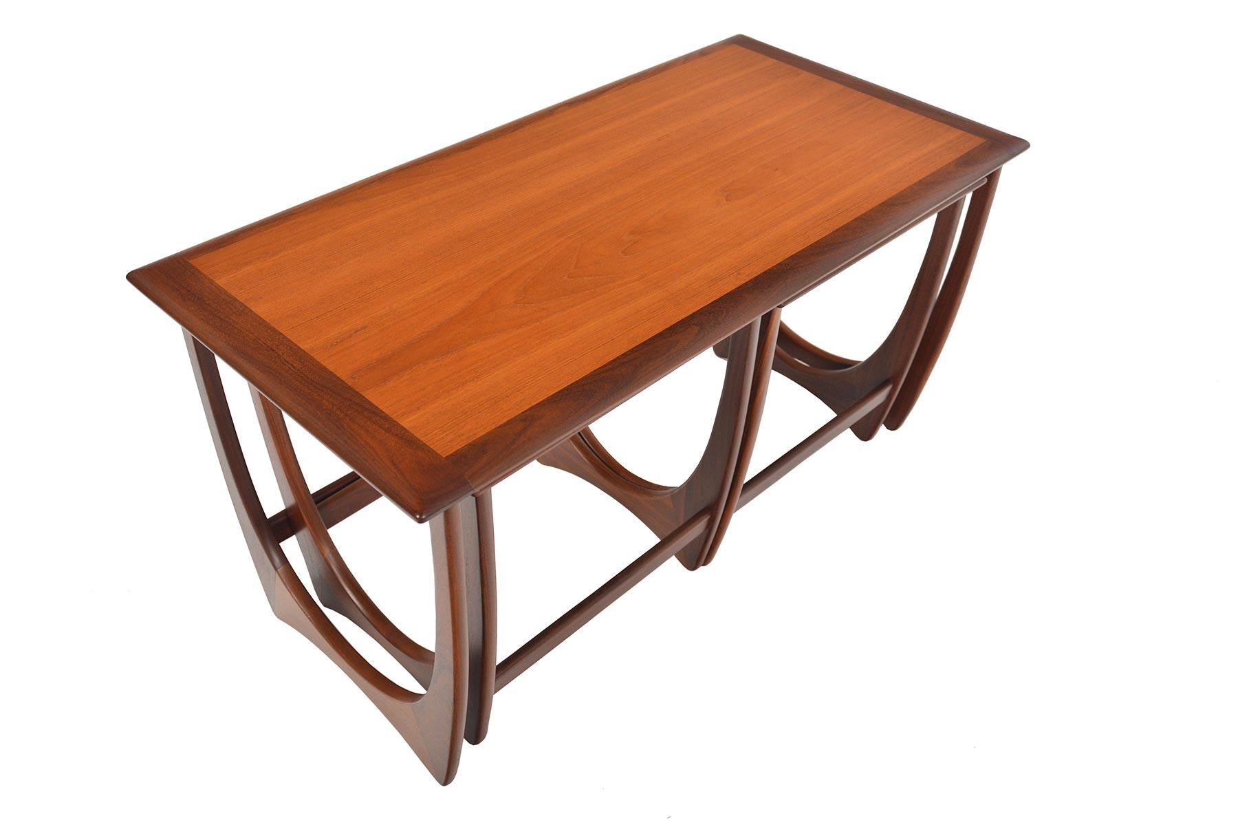 This timeless set of Mid-Century Modern G Plan Astro teak nesting tables was designed by Victor Wilkins in the 1960s. Gorgeous design and exceptional construction throughout. This rare configuration offers one large table and two matching side