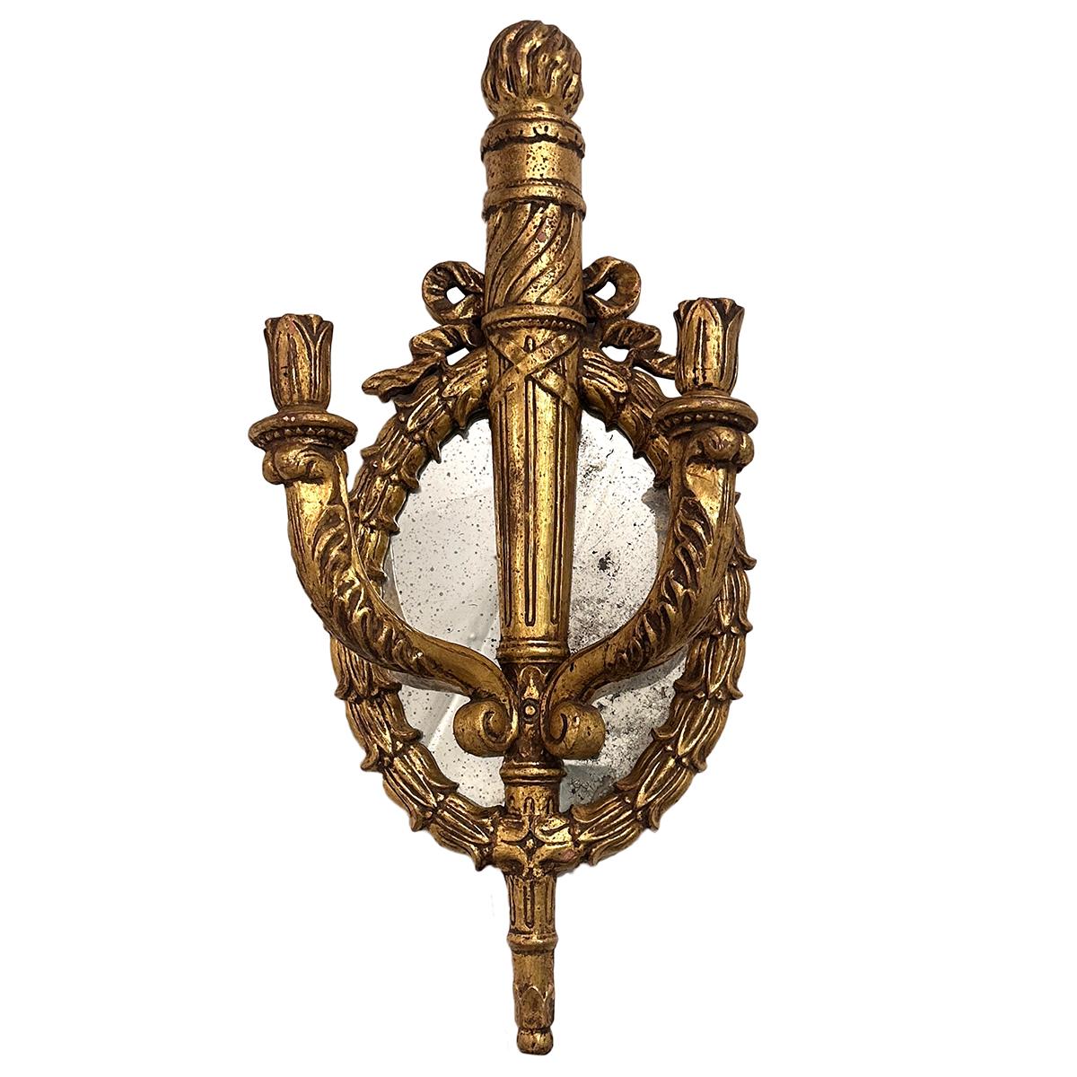 Set of four large circa 1930s Italian carved and giltwood double light sconces with mirror backs. 
Sold per pair.

Measurements:
Height 30