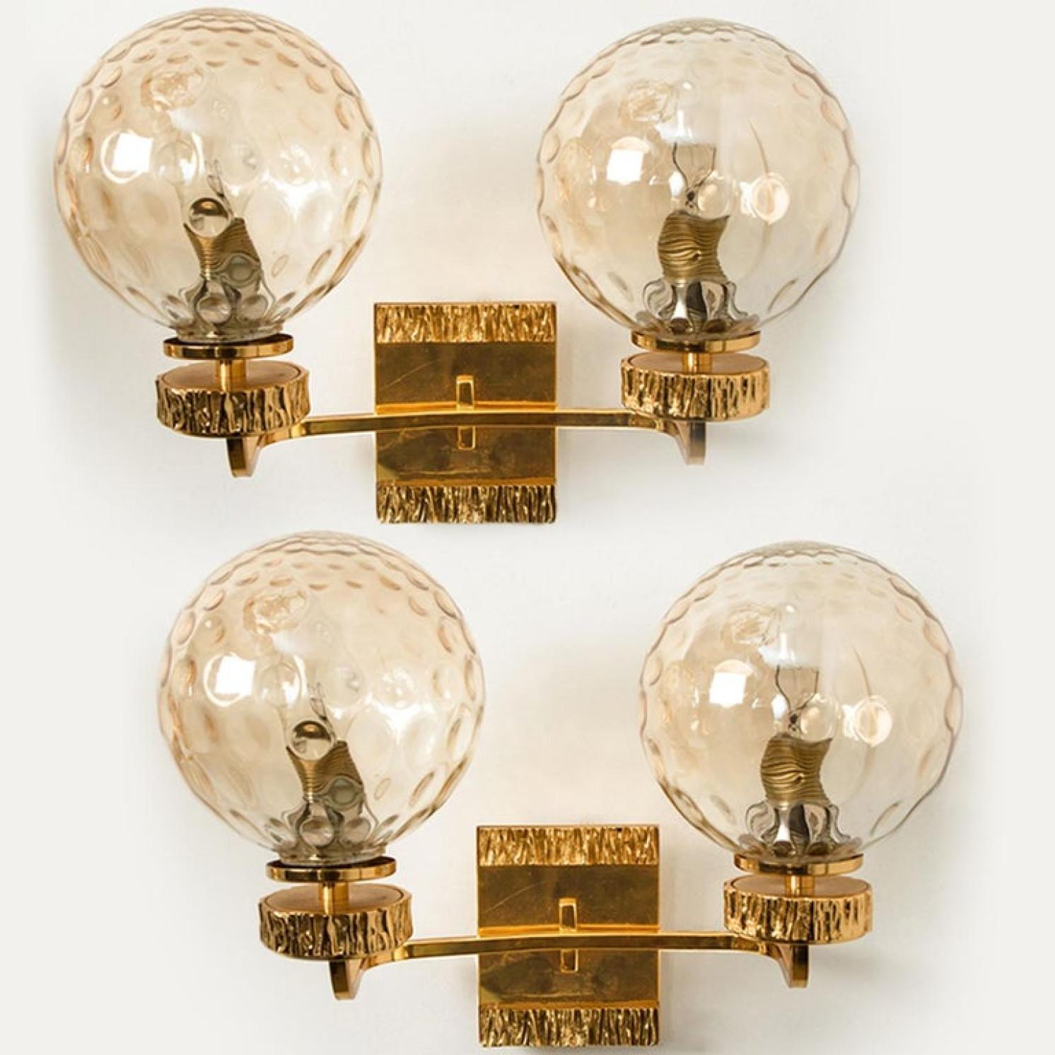This stunning set of wall lights with each one glass bowl and gold-plated fittings was produced in the 1970s in the style of Brotto. Illuminates beautifully. Elegant and fine, it is comfortable with all decor periods.

Sizes of the wall light H 9.85
