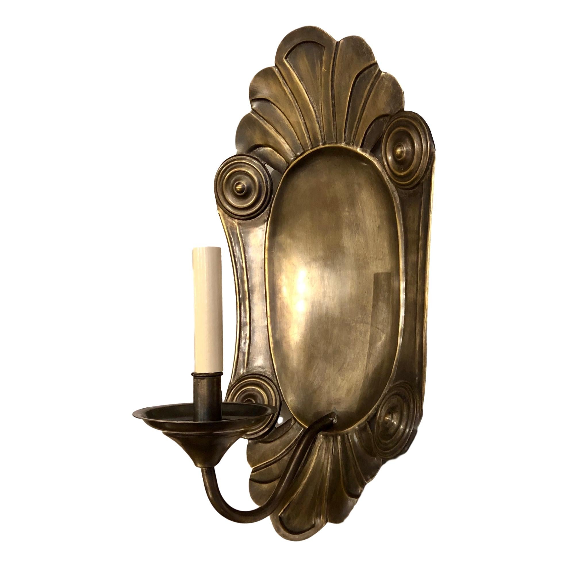 A set of four large circa 1940's Italian neoclassic style repousse' metal single-light sconces. Sold per pair.

Measurements:
Height: 18.5