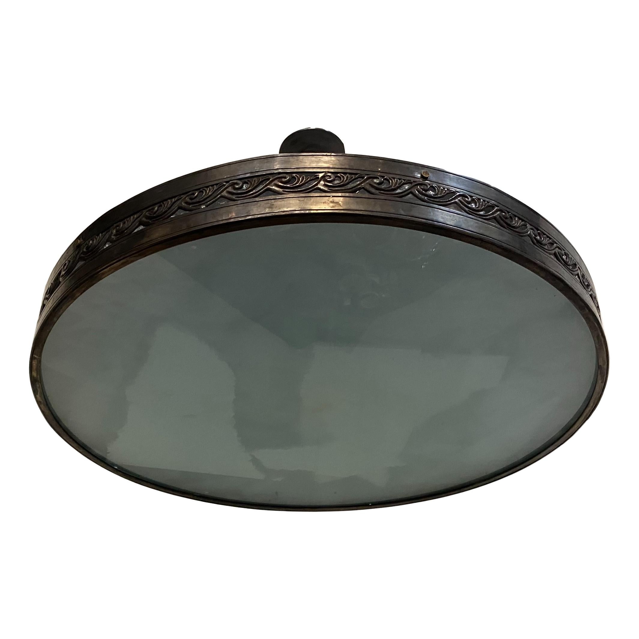 A set of three circa 1920's French patinated bronze semi-flush lights fixtures with frosted glass inset. Sold Individually.

Measurements:
Diameter 36