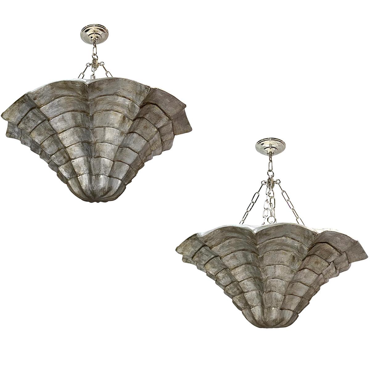 A set of 8 large circa 1940's French plaster light fixtures with silver leaf finish. The body in the shape of a large shell, with eight interior lights. Priced and sold individually.

Measurements:
Height: 40