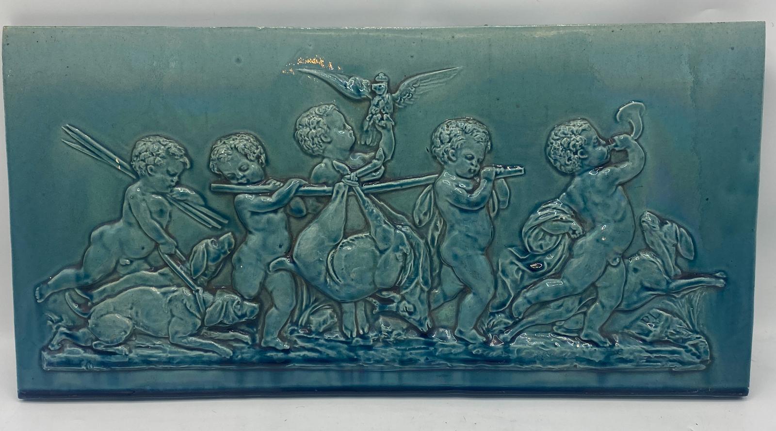 Late 19th Century Dunmore Pottery Victorian Green Glazed Ceramic Wall Plaques. These plaques were produced by Dunmore Pottery located on the estate of the Earl of Dunmore in Stilingshire, Scotland and depict cherubs on the hunt. The potter was Peter
